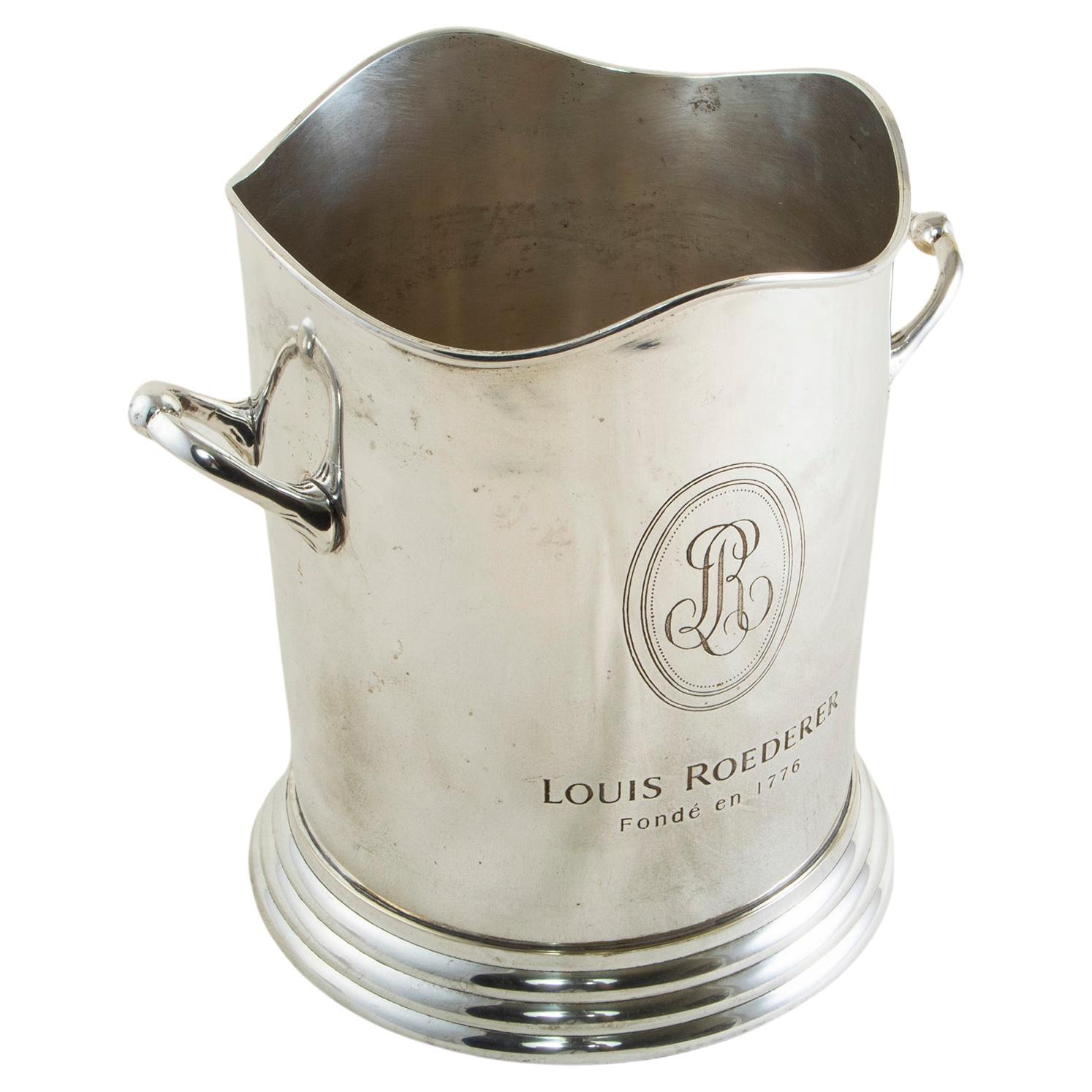 This French silver plate champagne bucket from the mid-20th century is marked on both sides Louis Roederer, Fonde en 1776, the name of the renowned champagne producer and the year of its establishment. A curved rim at the top and tiered footed base