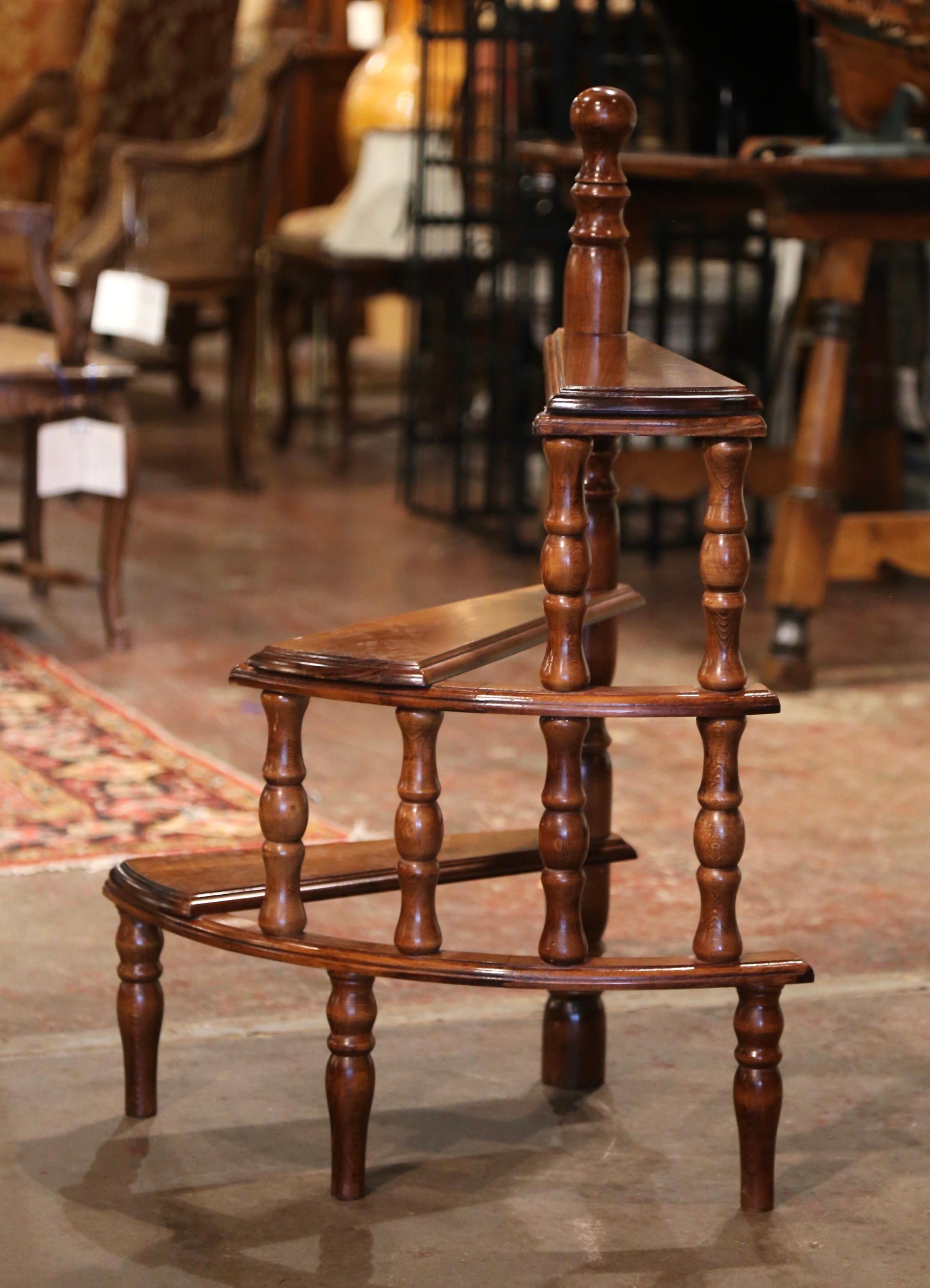 Use this vintage fruitwood spiral staircase to organize books in your office or library. Created in France circa 1970, the small circular step ladder sits on four small turned feet and each of the three stairs rolls around a central post decorated