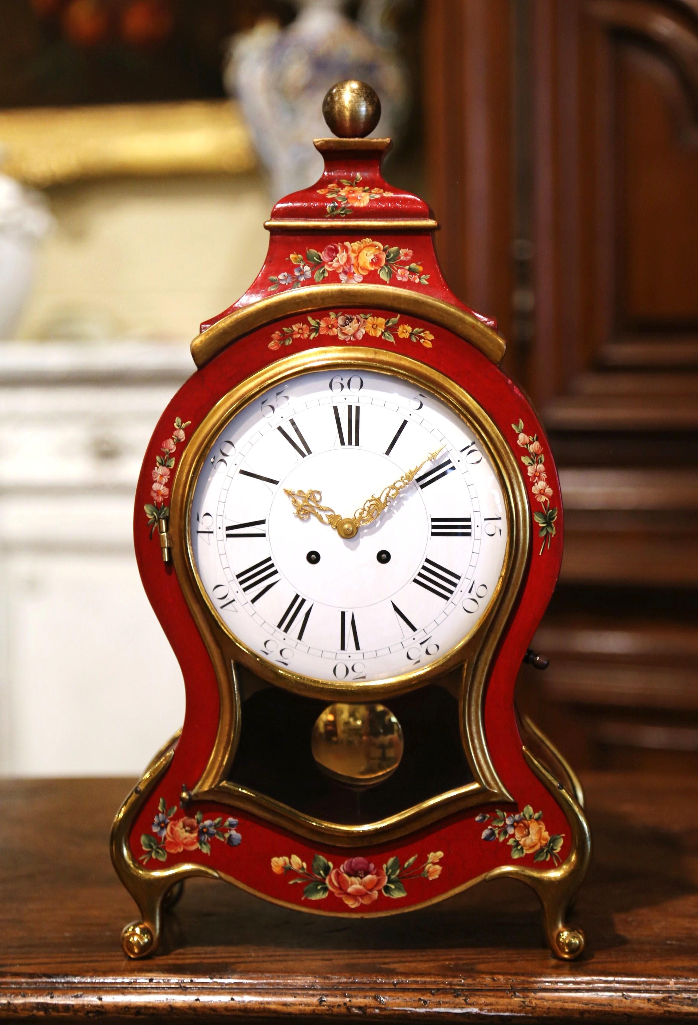Place this colorful painted antique clock on a mantel or a desk. Crafted in France circa 1960, the elegant violin shaped clock sits on four gilt scrolled feet over a scalloped apron and bowed sides. The clock mechanism with porcelain face and brass