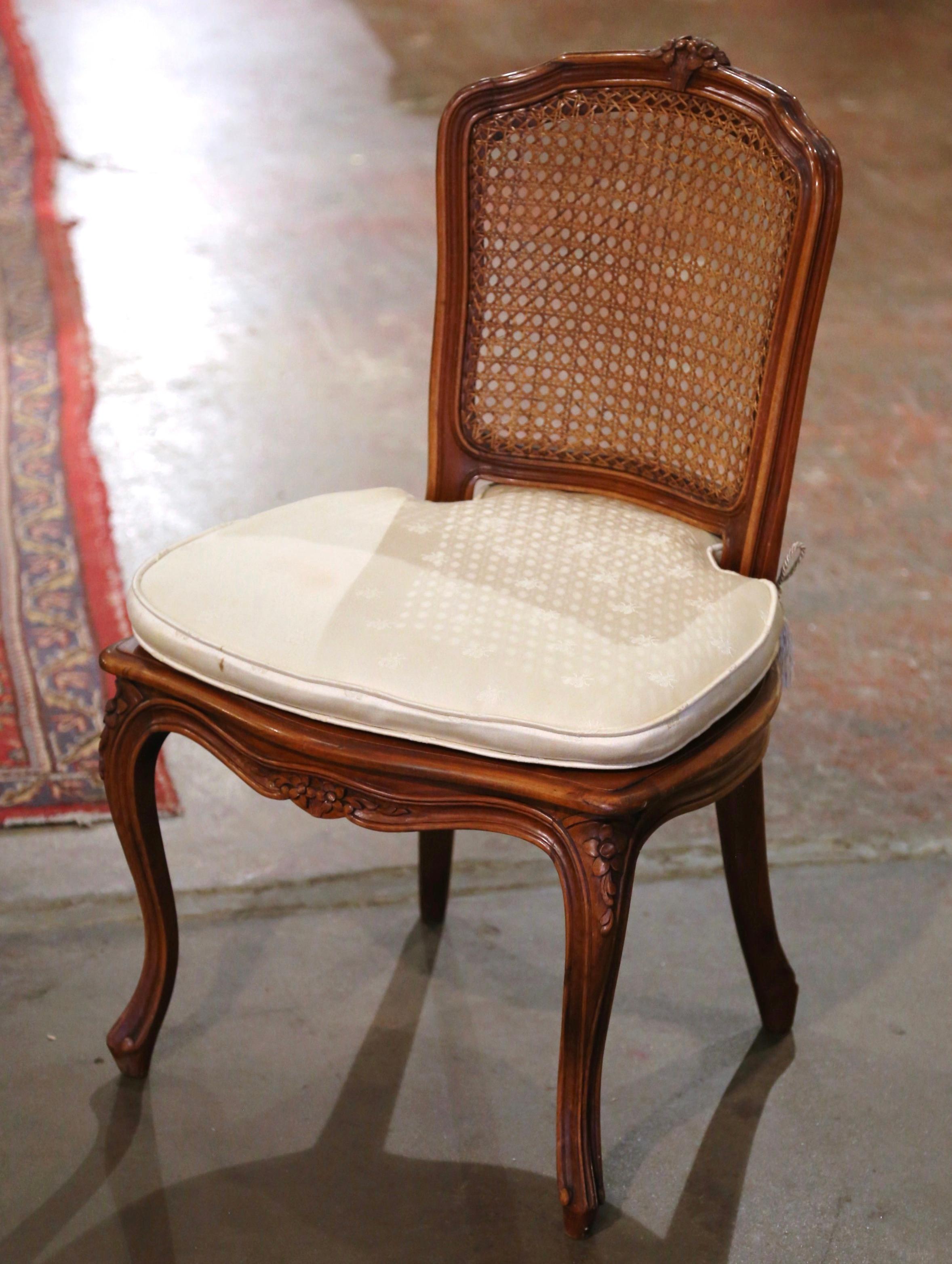 Add charm to a family friendly living room or nursery with this elegant low chair. Crafted in France circa 1970 and nicely carved, the antique chair stands on cabriole legs decorated with floral medallions at the shoulder, over a scalloped apron