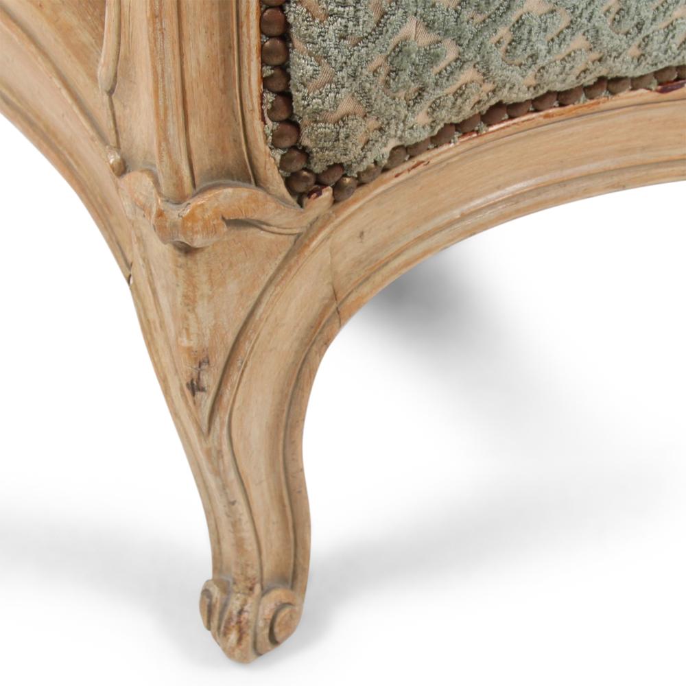 A French Louis XV style upholstered bed, the head and foot boards with nicely shaped and carved frames, the lines of which flow smoothly into the carved shaped side rails, all raised on carved cabriole legs with scroll feet.

 