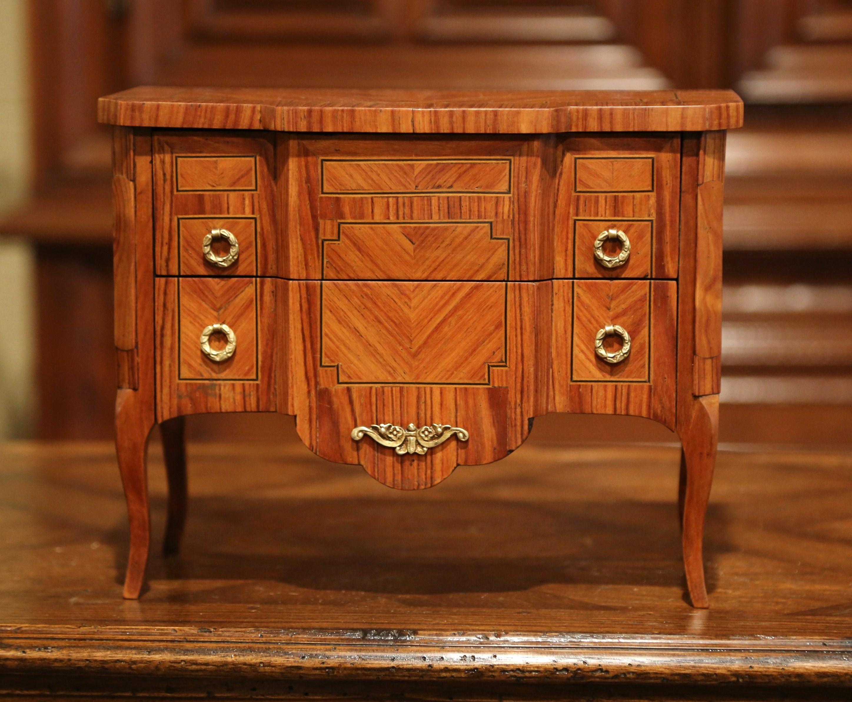 Decorate a master bathroom counter with this miniature chest of drawers. Crafted in France circa, 1960, the petite fruitwood 