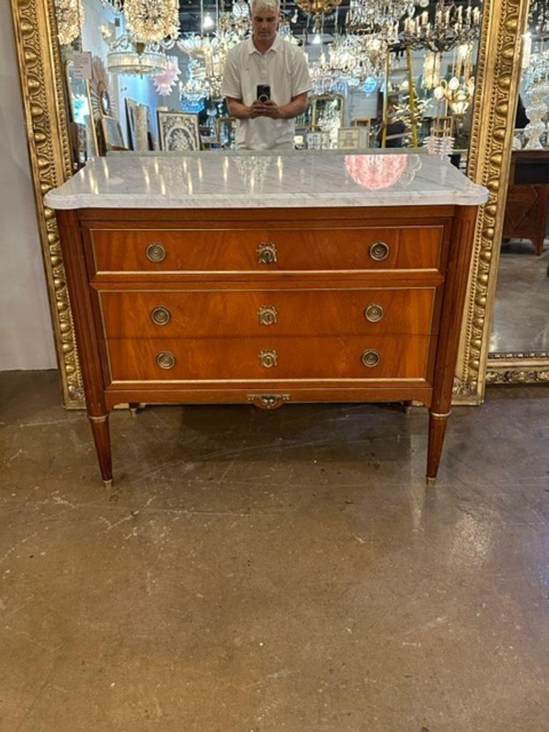 Lovely mid 20th century French Louis XVI mahogany chest with carrara marble top. Nice brass trim and hardware as well.  Perfect for a traditional look.  Very pretty!!

