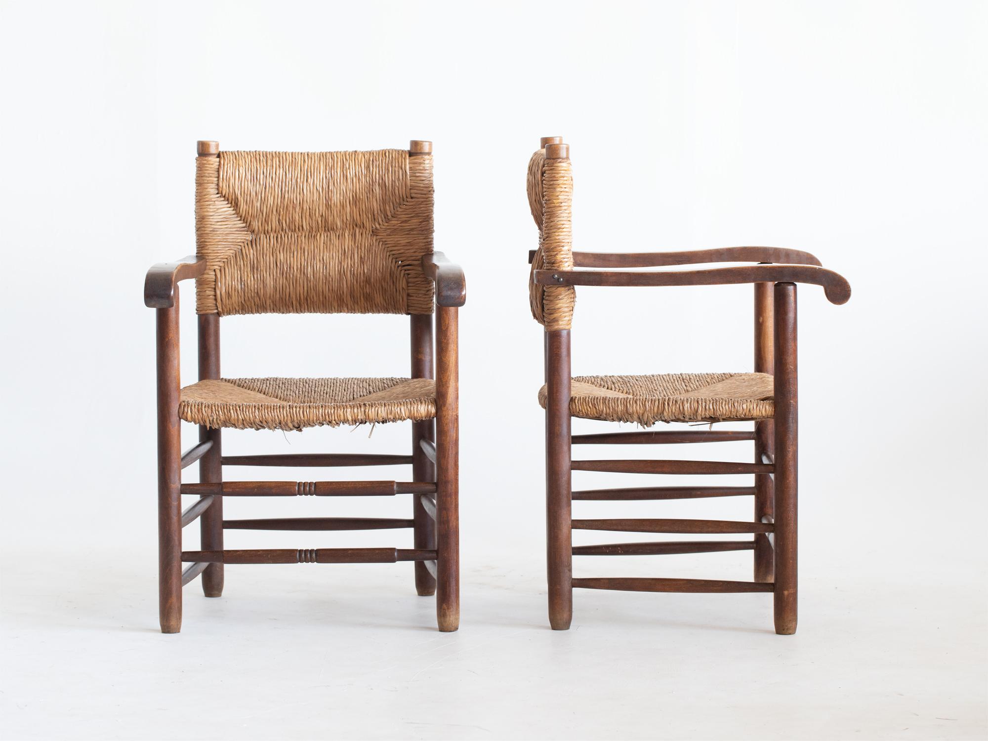 A pair of modernist carver armchairs with rush woven over stained beech frames. French, c. 1950s.

Stock ref. #2207

Sturdy frames, all rush work strong and serviceable as is with minor faults.

87.5 x 57 x 56 cm (34.4 x 22.4 x 22.0 
