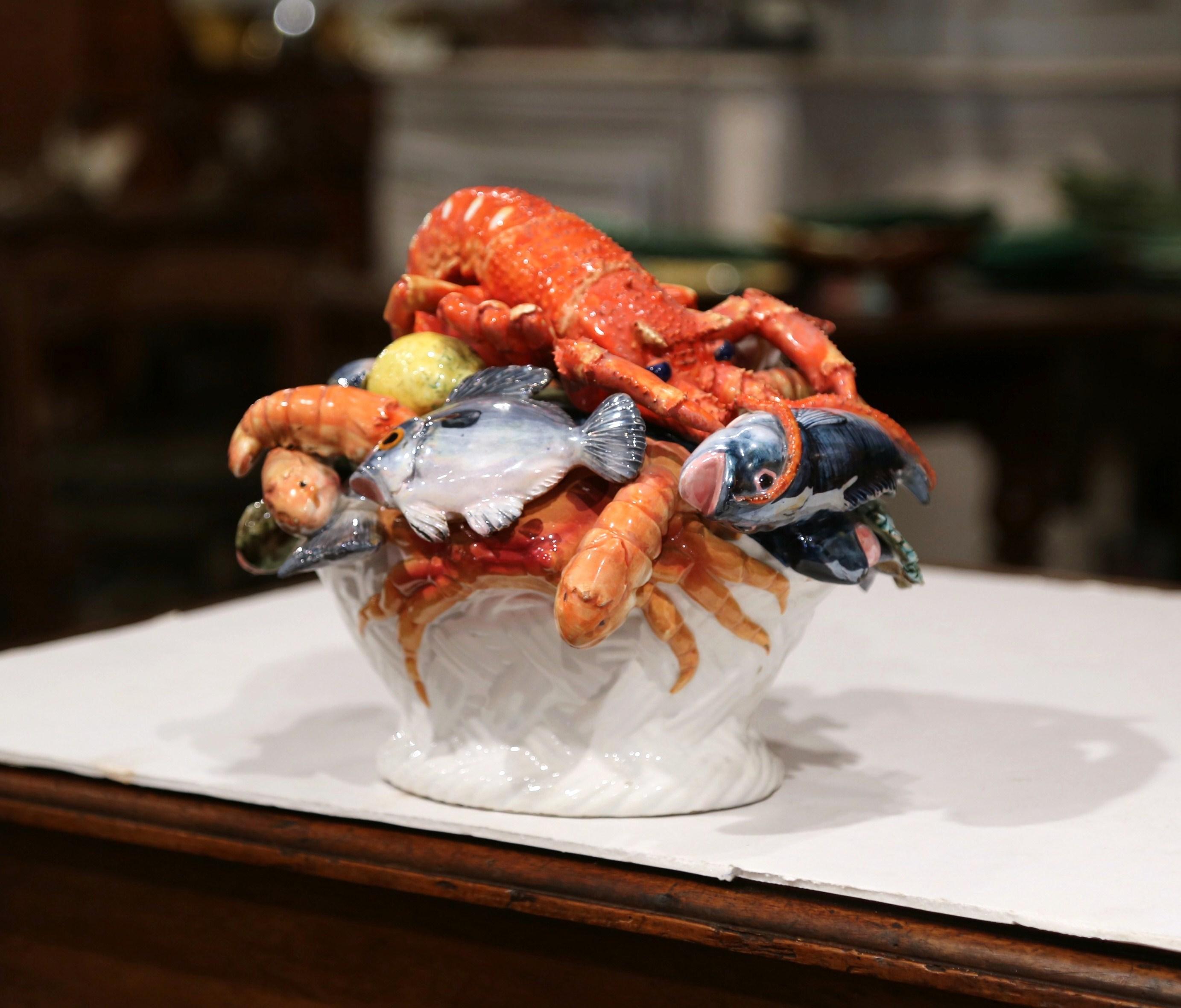 Decorate a tabletop in your kitchen or dining room with this colorful Majolica basket composition. Crafted in France circa 1950, the detailed centerpiece features an assortment of sculptural seafood in high relief that includes lobster, crabs, six
