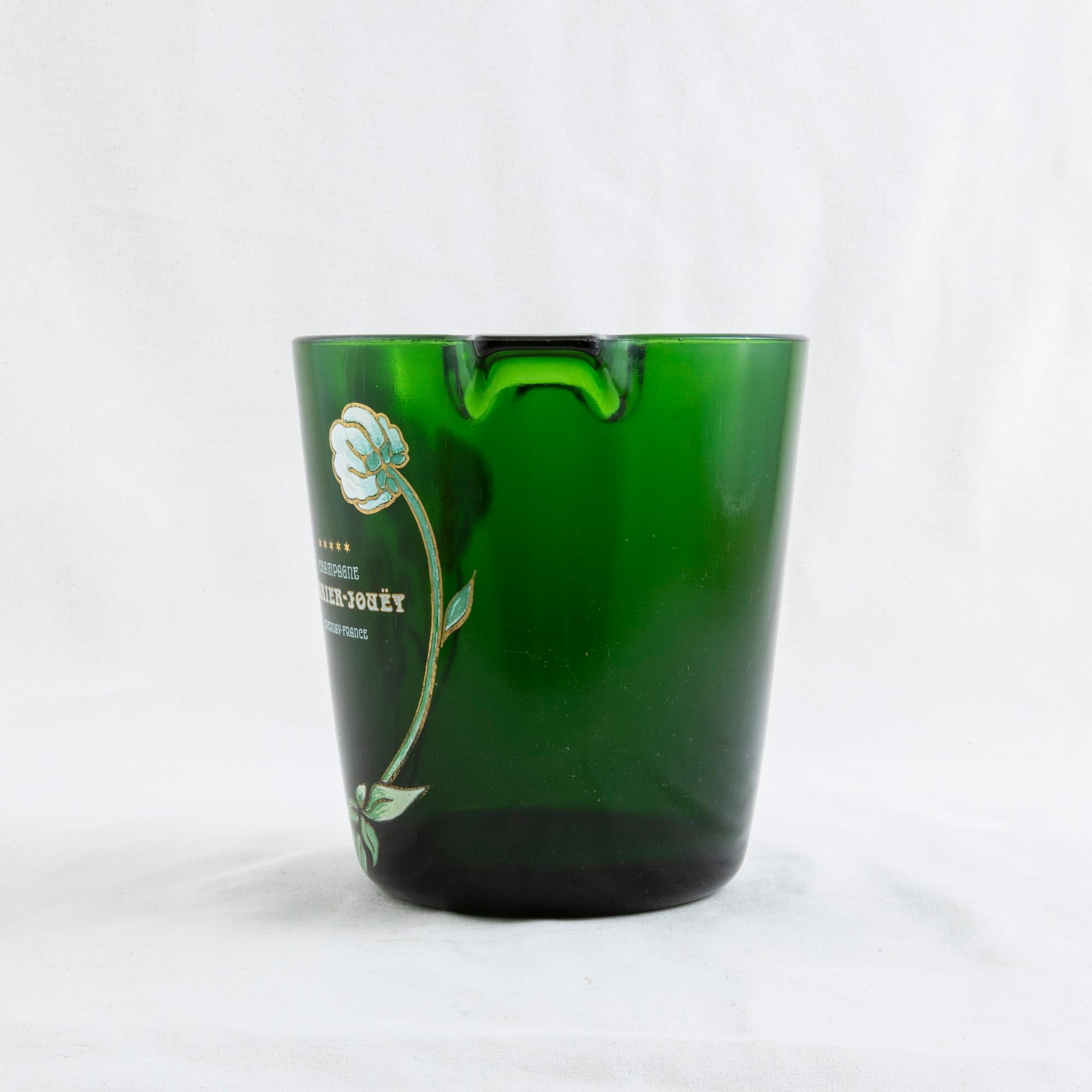 This special edition French green glass champagne bucket from the mid-twentieth century is marked with the hand enameled name of the champagne producer Perrier Jouet. Iconic hand enameled white flowers, closely associated with the company, flank the