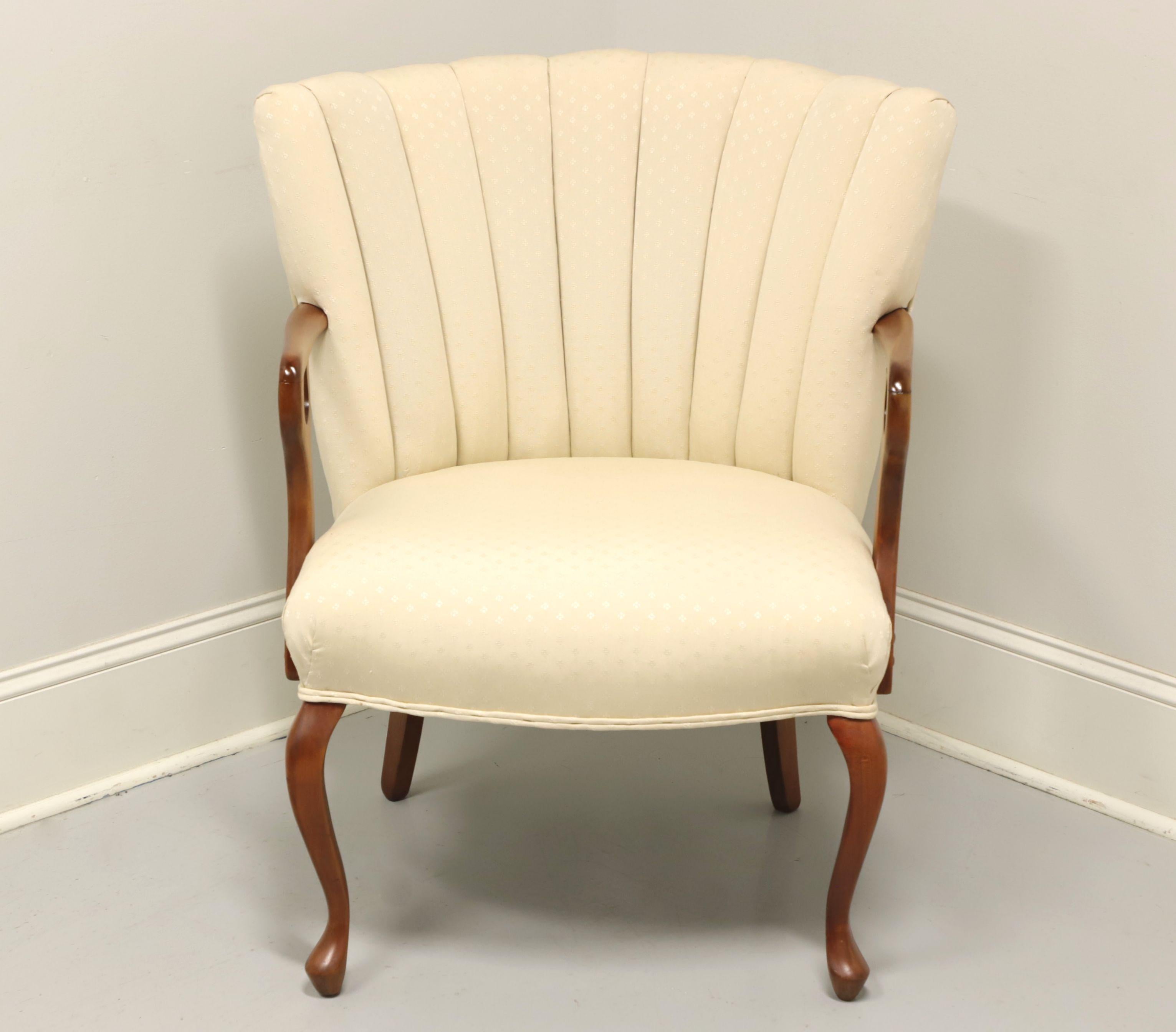 A vintage French Provincial upholstered accent armchair, unbranded. Mahogany frame with rounded arms, channel back and cabriole front legs. Features an upholstered fabric in a neutral cream color. Made in the USA, in the mid 20th Century.