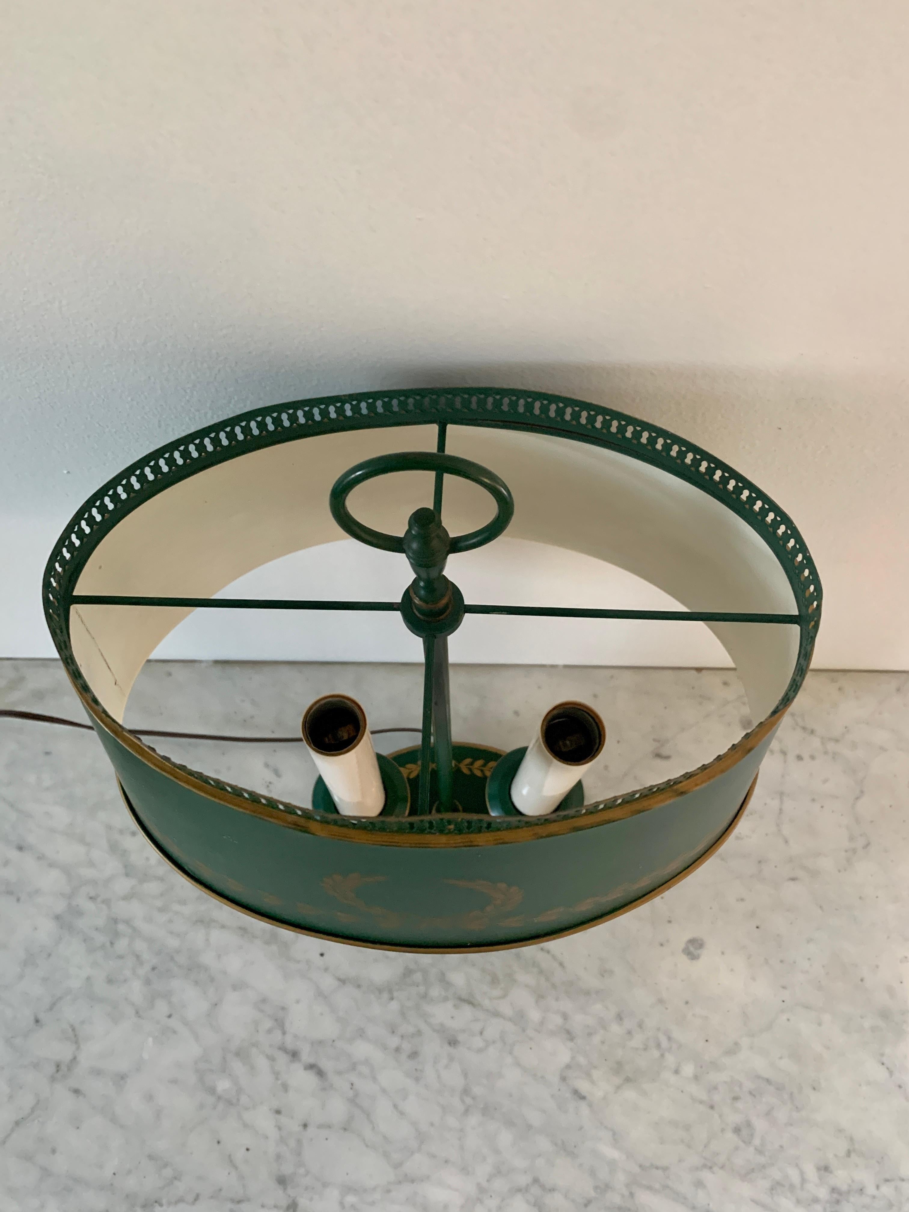 A gorgeous neoclassical or French Regency style green and gold tole bouillotte lamp 

USA, Mid-20th Century

Measures: 11.75