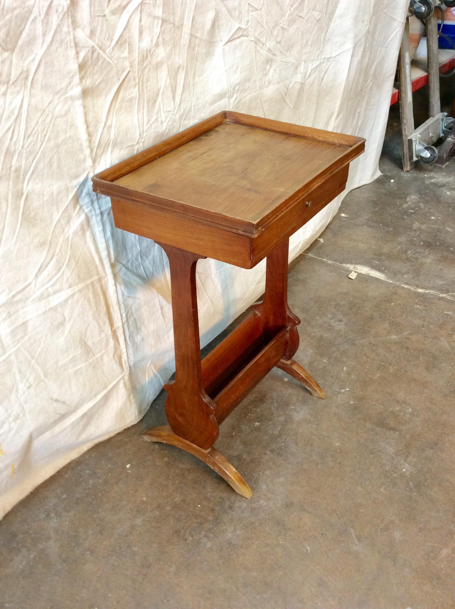 This petite walnut table has one drawer and a small storage space on the bottom, possibly for a book or magazine. It would be great beside a cozy chair or perhaps in a bedroom. Vintage from France, ready to find it's place in your home.

15.5