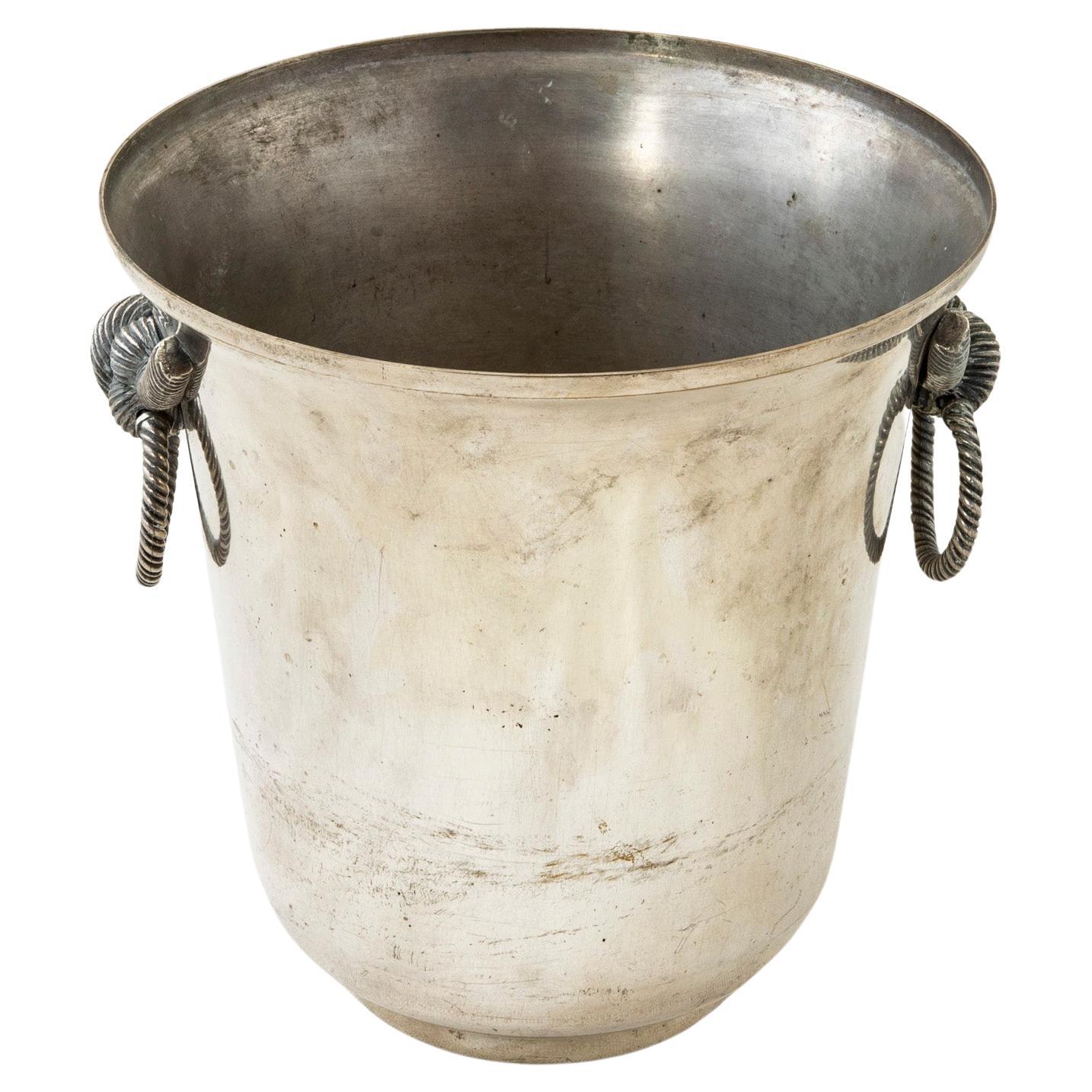 This mid-twentieth century French silver plate champagne bucket features knot handles with drop rings. A wonderful addition to any dry bar. c. 1950.