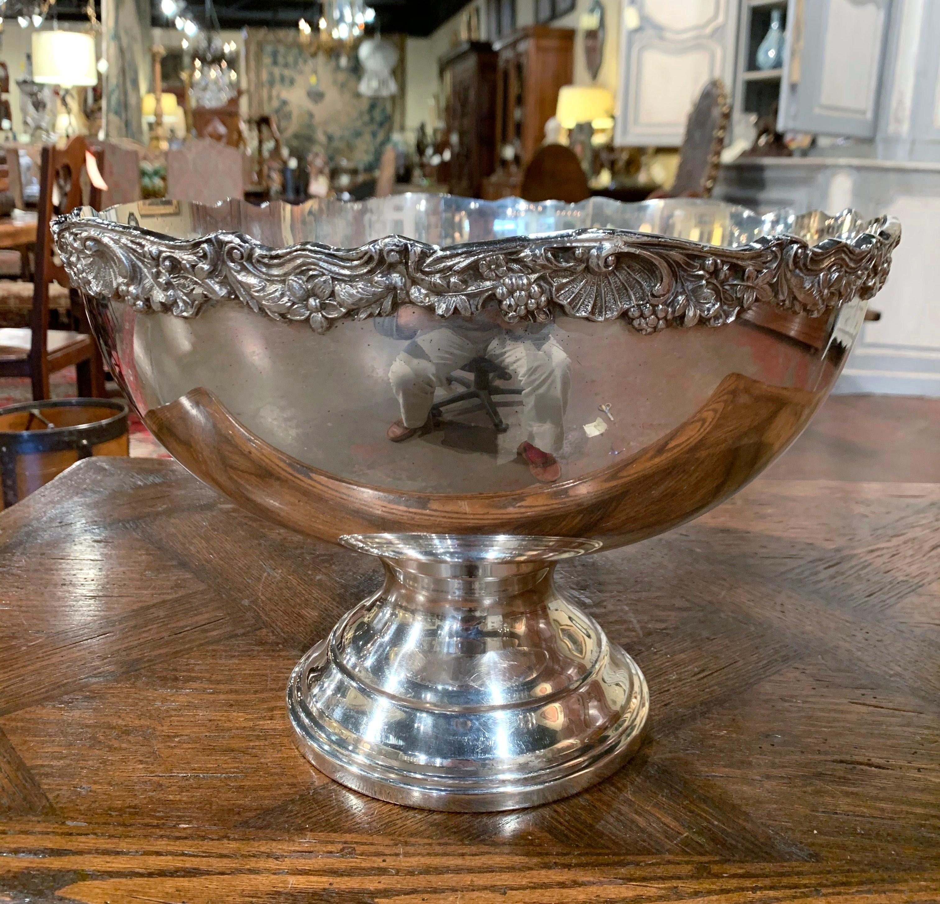 Keep your wine or champagne chilled in style with this elegant round bowl; crafted in France circa 1960 and made of silver plated over brass, the circular bowl stands on a round base; it features a scalloped rim decorated with repousse grape and