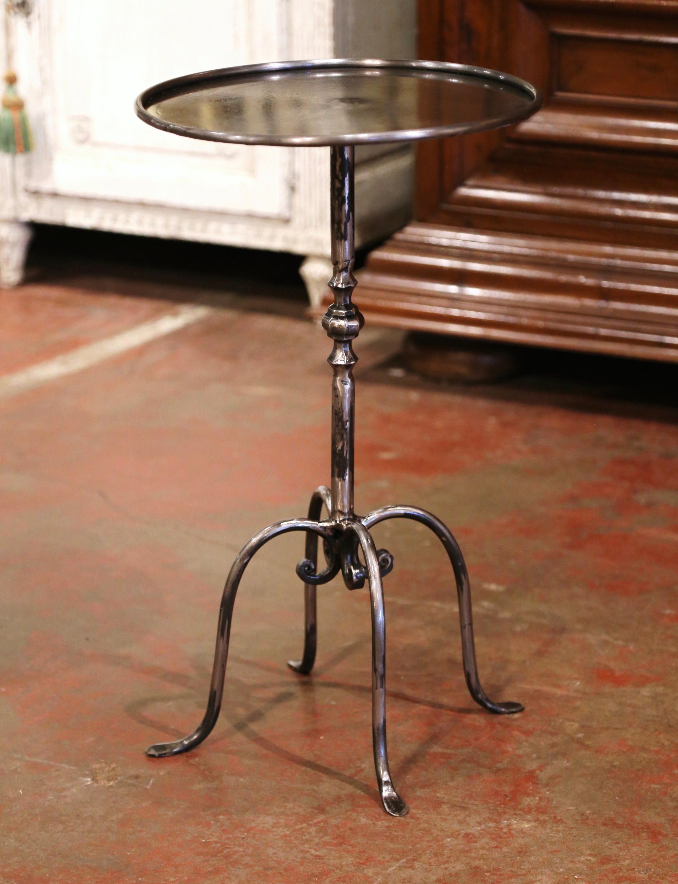 This elegant, antique pedestal table was crafted in Southern France, circa 1960. The martini table features a central pedestal stem over four scrolled legs ending with small feet. The serving table is topped with a round surface from later addition,