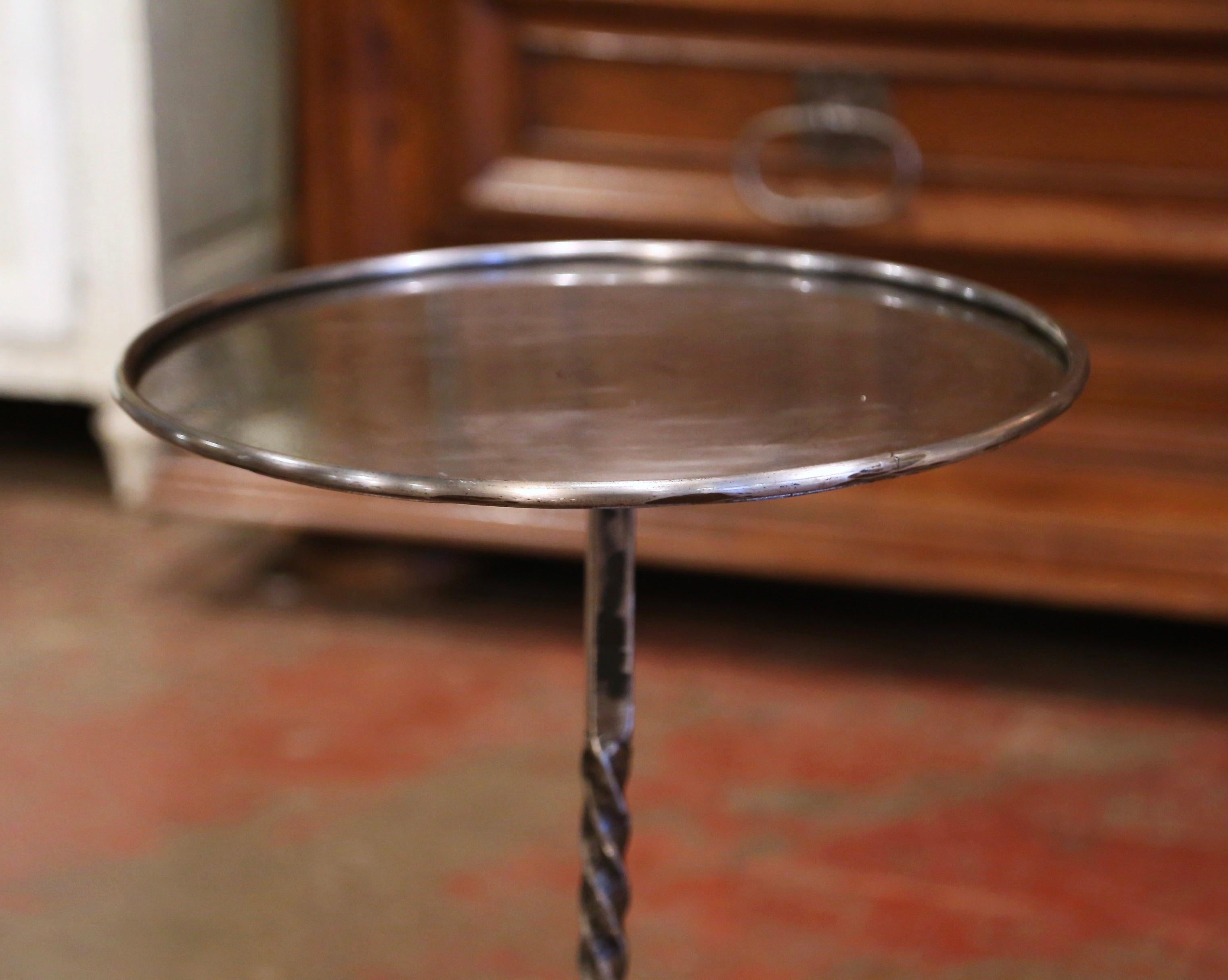 This elegant, antique pedestal table was crafted in Southern France, circa 1960. The martini table features a central twisted pedestal stem over four scrolled legs ending with small feet. The serving table is topped with a round surface from later