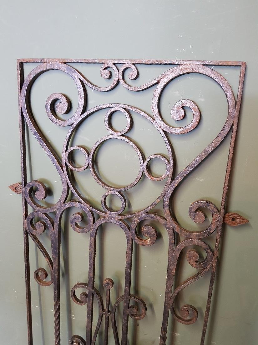 Old French wrought iron door grille decorated with various curls and twisted elements, these are further in a good but used condition. Originating from the mid-20th century.

The measurements are,
Depth 2 cm/ 0.7 inch.
Width 56 cm/ 22