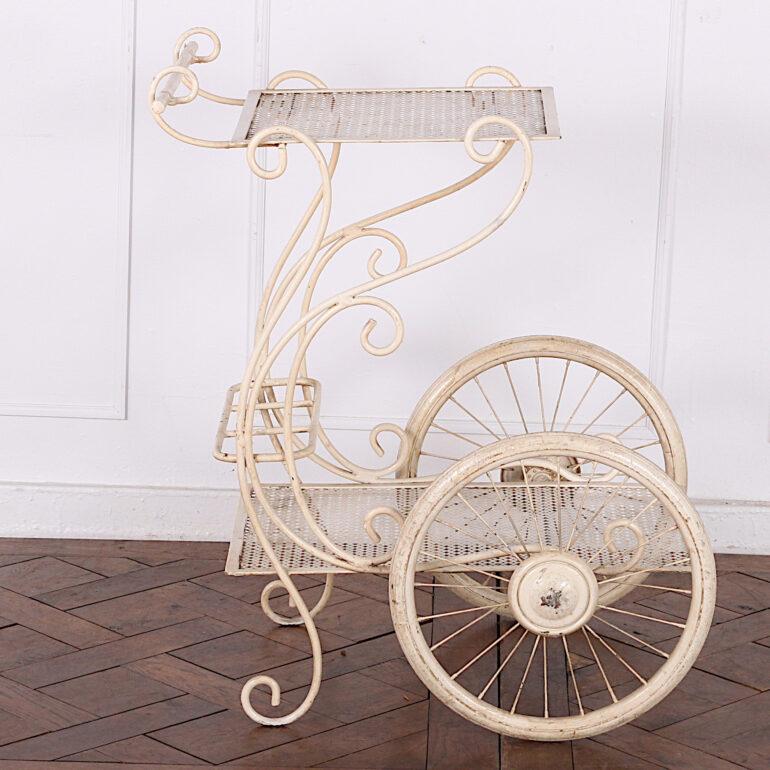 A vintage French wrought iron trolley or drinks cart with a playful scrolled design and rolling on a pair of large spoked wheels. Perfect for Summer patio / barbeque outdoor entertaining season. 



  