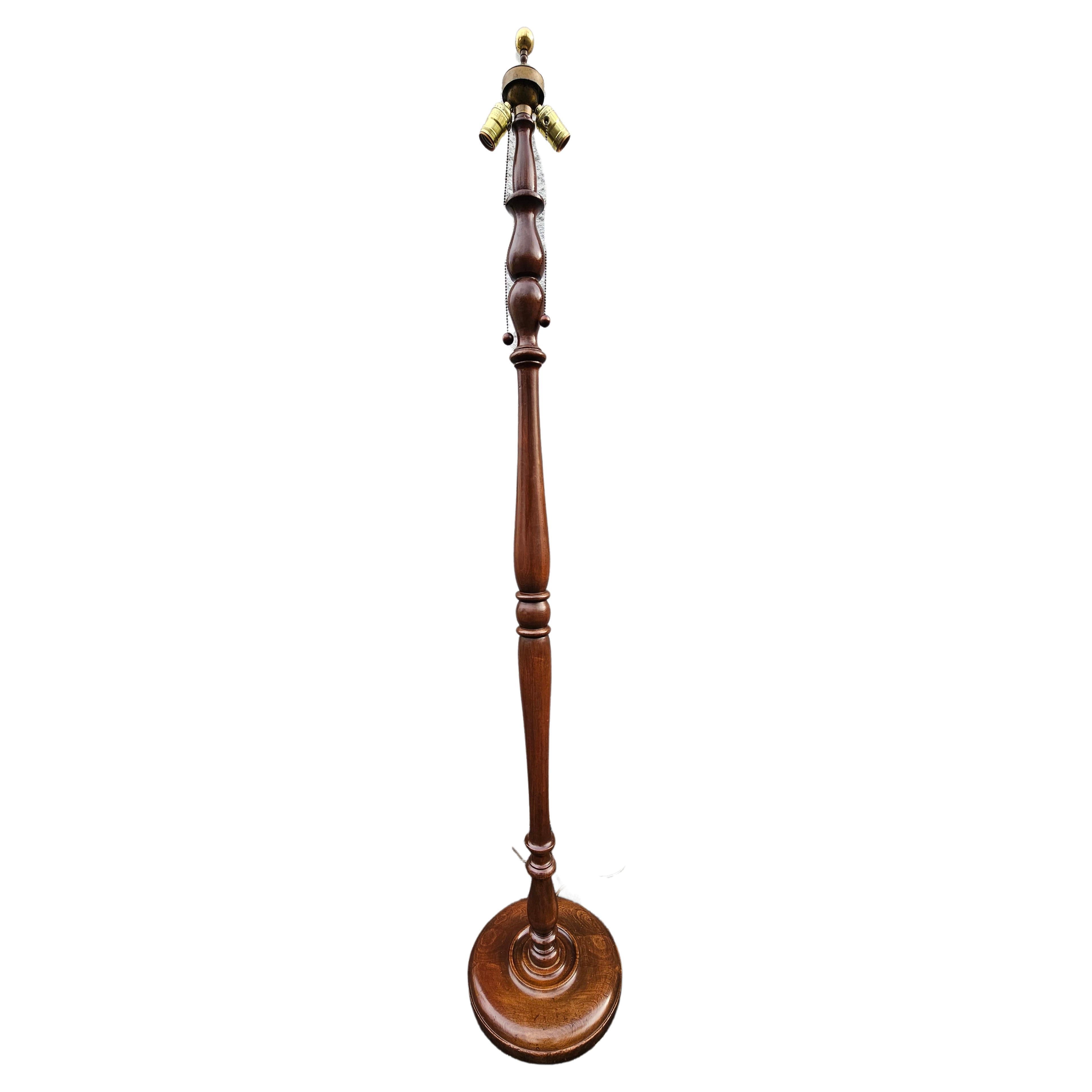A Mid 20th Century Fruitwood Spindle Two-Light Floor Lamp with brass Ball finial.
Measures 12.5