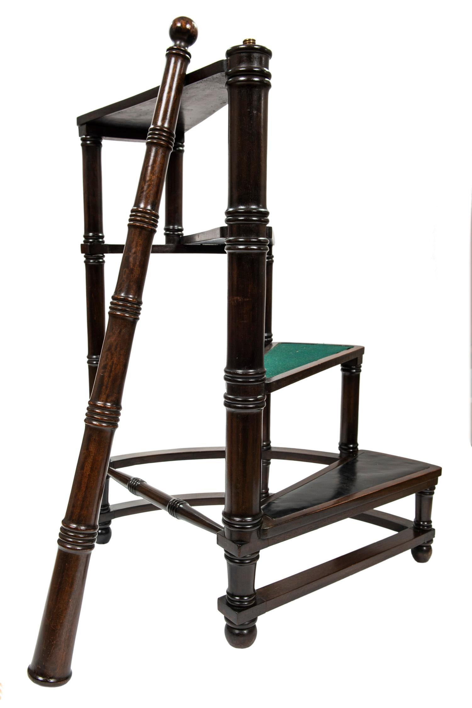 This Classic four step spiral Georgian style library ladder is made of mahogany with a removable( see photos) turned support. The steps are clad in black leather and green felt.