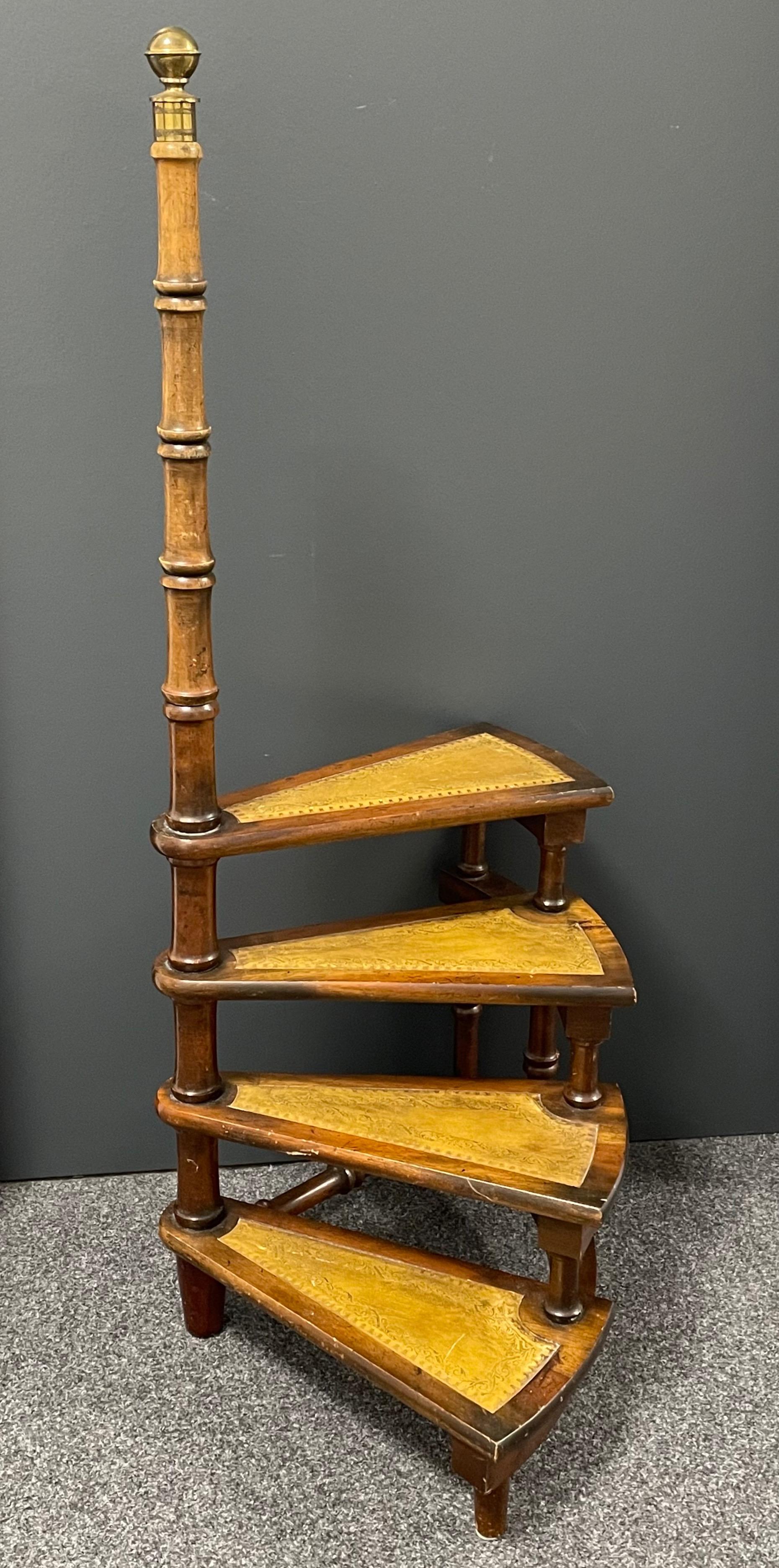 Created in Germany circa 1960 and standing on turned legs, the tall circular step ladder features four stairs rolled around a turned, central post embellished with a decorative brass finial at the pediment. Each step is upholstered with the original