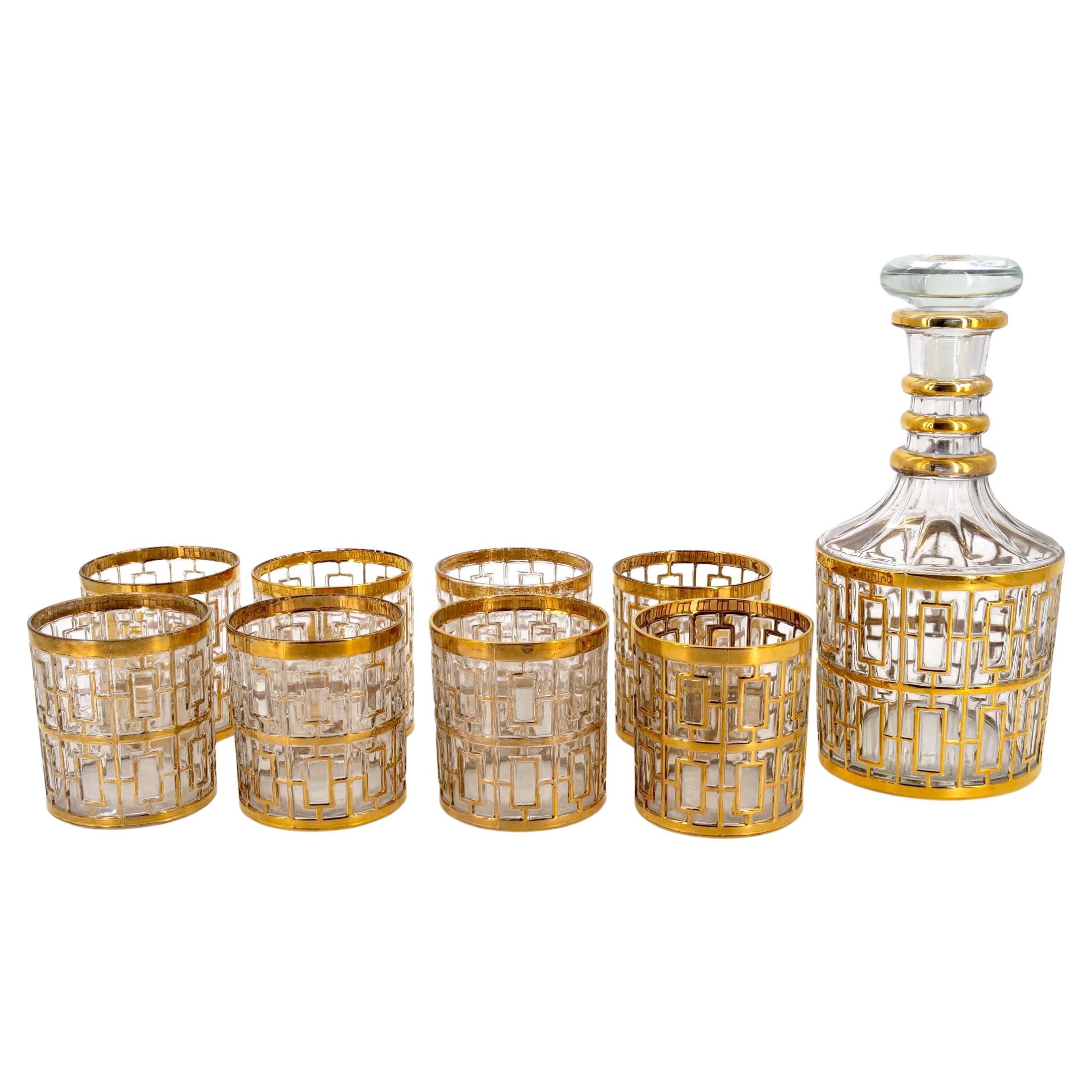 Mid 20th century gilt glass barware / tableware whiskey service for eight people with one decanter.  Each piece is in great condition. Minor wear to gold consistent with age / use. Maker's mark undersigned . The decanter measures 9 1/2 inches tall X