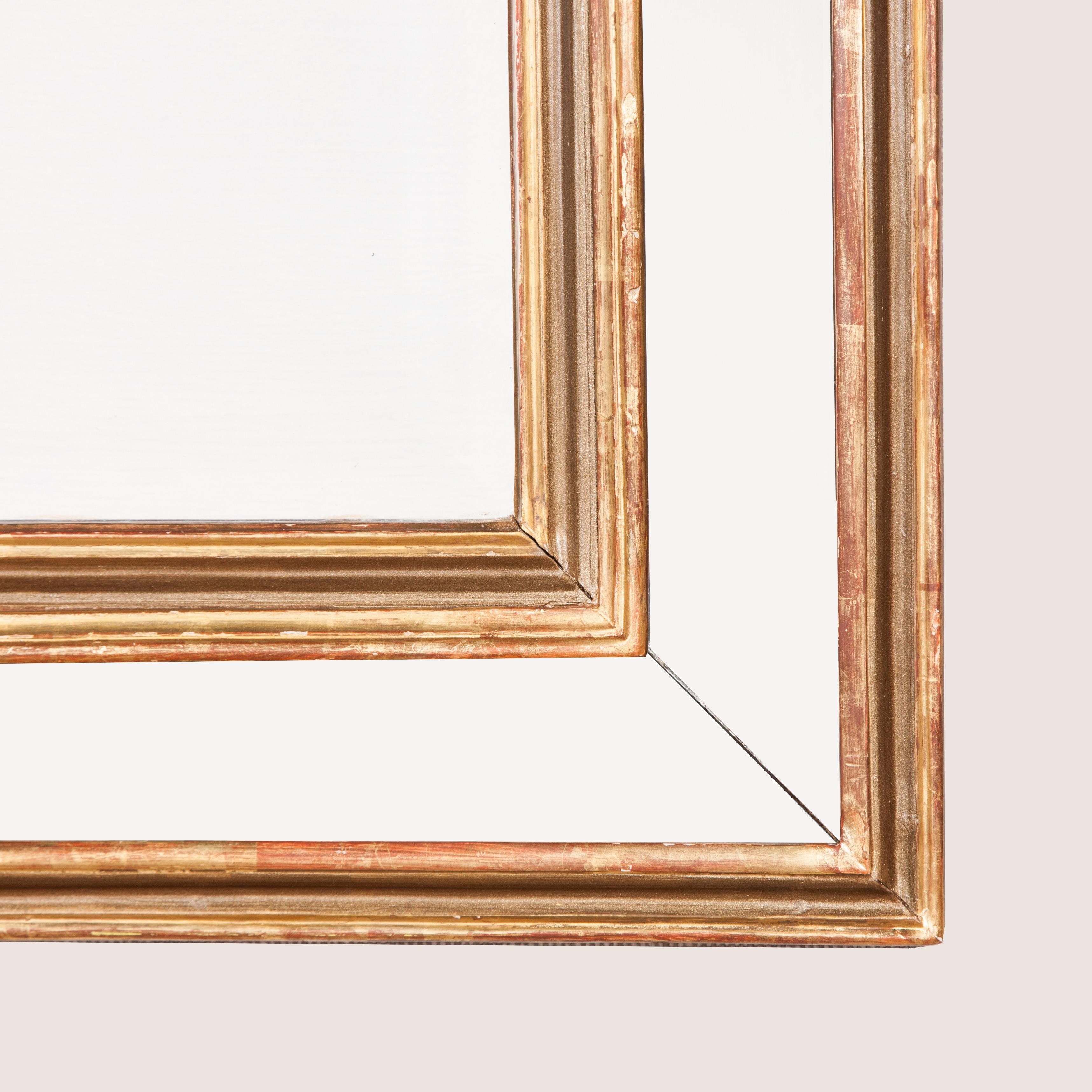 A rectangular mirror with a giltwood and mirror glass bordered frame, early to mid-20th century.
