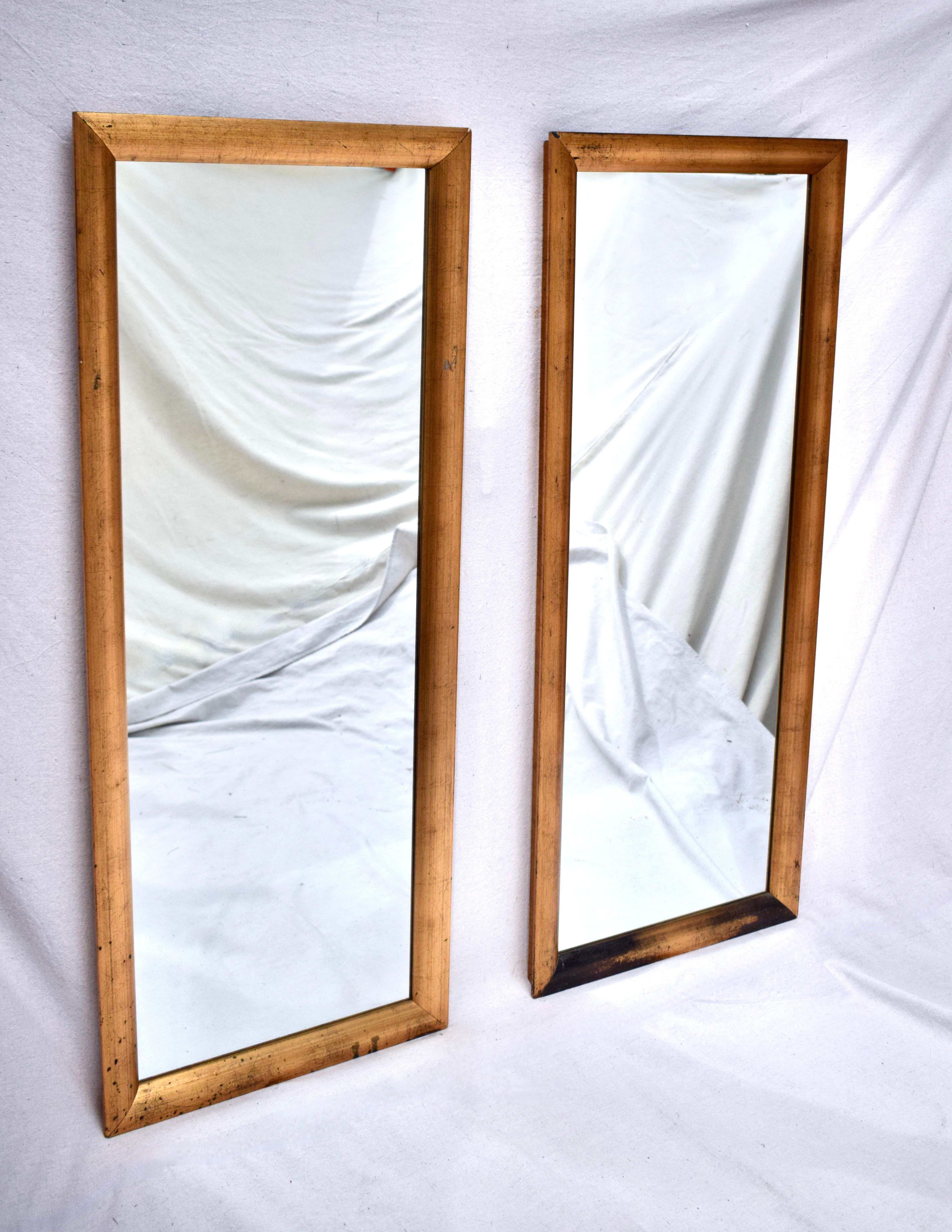A pair of 1960s gold gilt wall mirrors in beautifully maintained vintage condition ready to hang. Generous in Size & marvelously transitional, suitable for various settings from Modern to traditional. 52