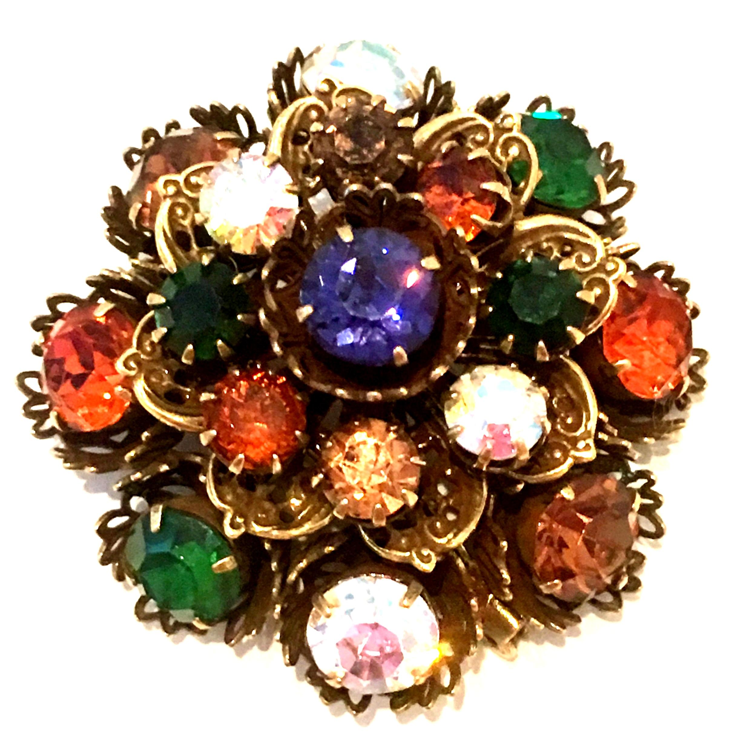 Mid-20th Century Gold Vermeil Dimensional Austrian Crystal Brooch By, Coro. This coveted dimensional gold vermeil brooch features exceptional craftsmanship with large and small fancy prong set brilliant round Austrian Crystal stones. The larger