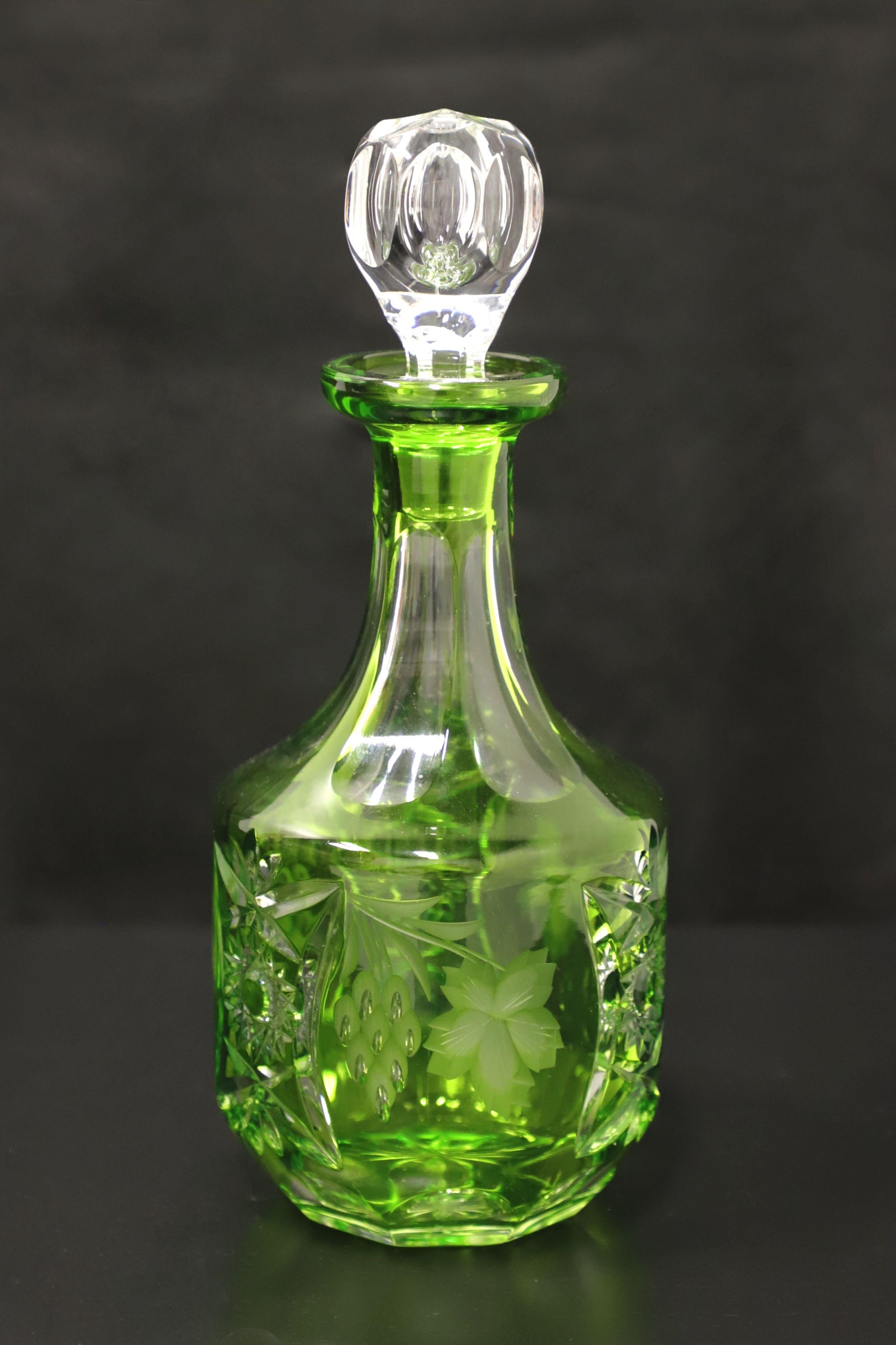 A Mid 20th Century crystal decanter. Emerald green cut decanter with alternating star and grapes with leaves motifs. Clear cut round stopper. Origin unknown, most likely the USA.

Measures: 4.5 W 4.5 D 10.75 H, Weighs Approximately: 2