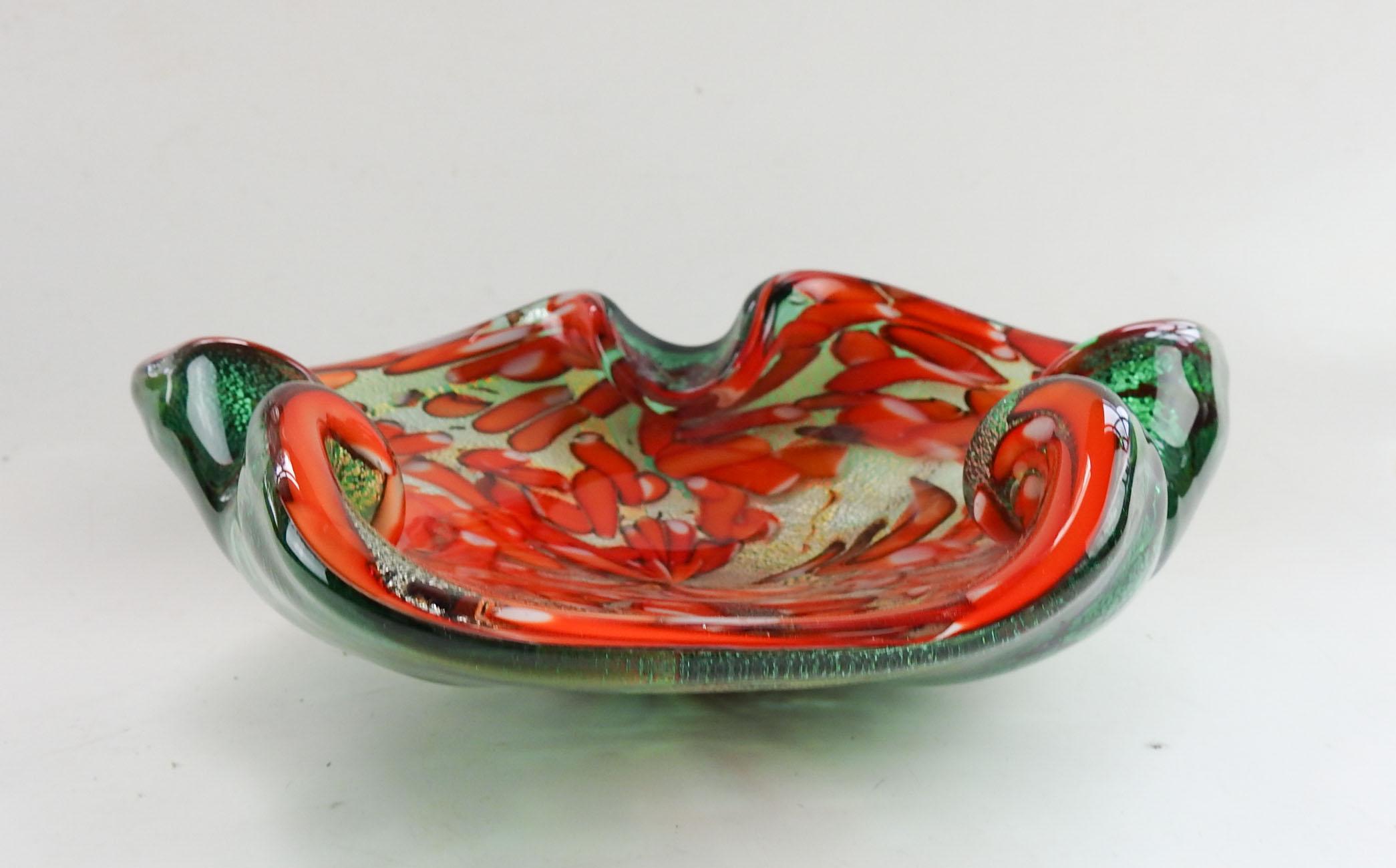 Vintage Murano glass bowl or ashtray. Green with gold leaf layer, orange and white canes. Couple tiny manufacturing bumps on bottom.