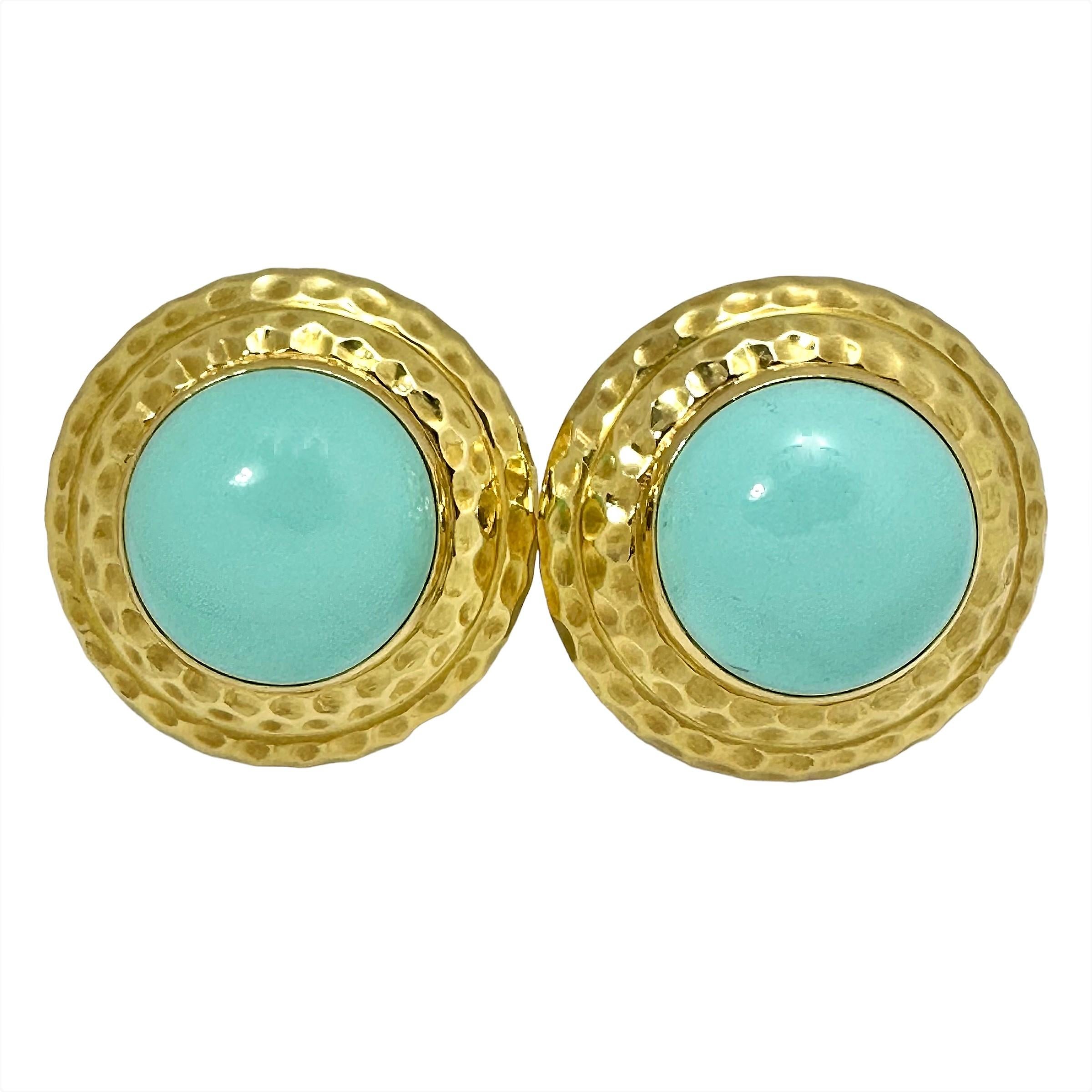 Made in America of Hammered finish 18K yellow gold with an 11/16 inch diameter turquoise cabochon in the center of each, these beauties make a strong impression. The high level of workmanship and materials, make them a pair to be admired. Measures 1