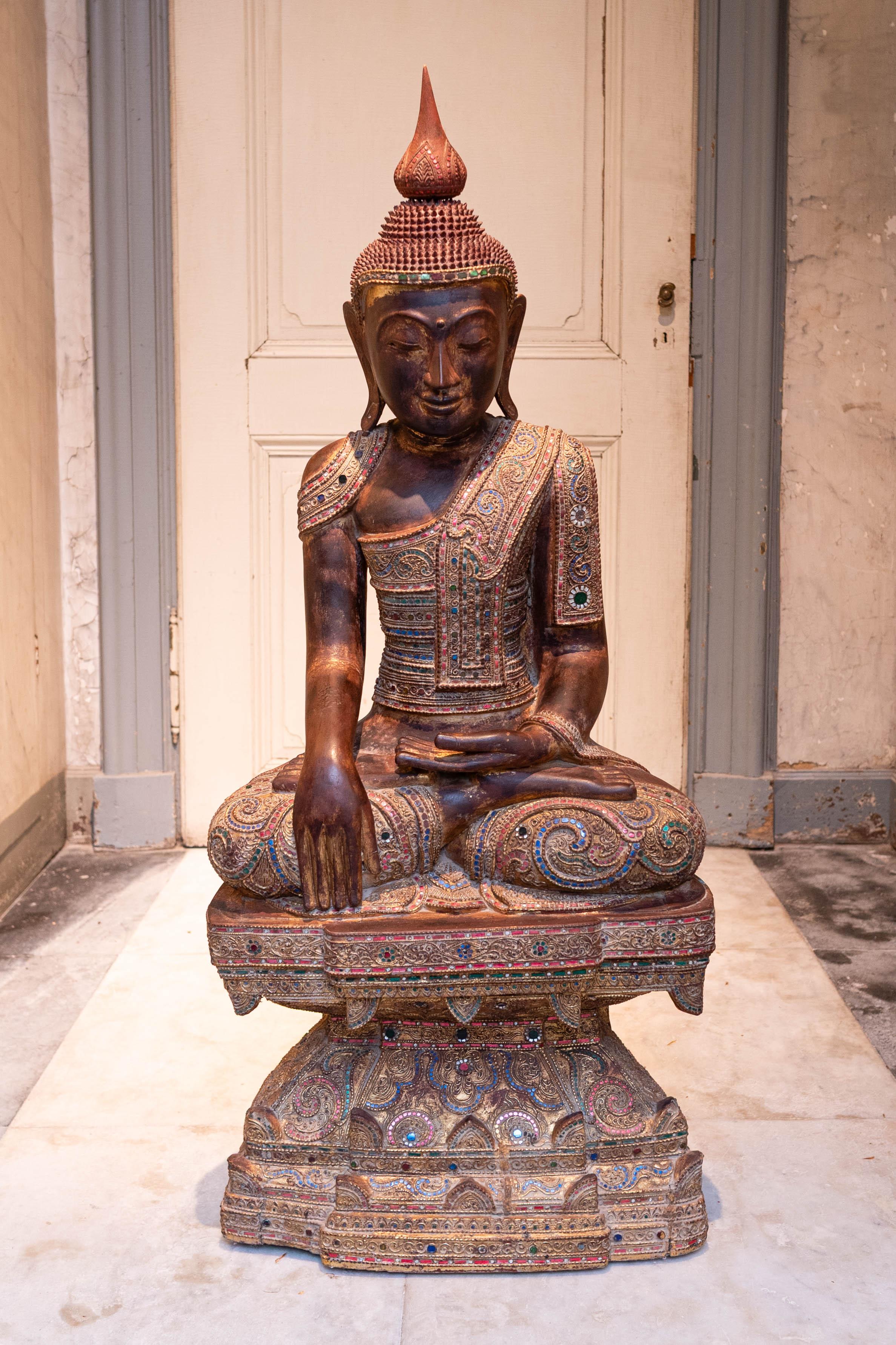 Beautifully decorated and hand-carved sitting buddha statue. 