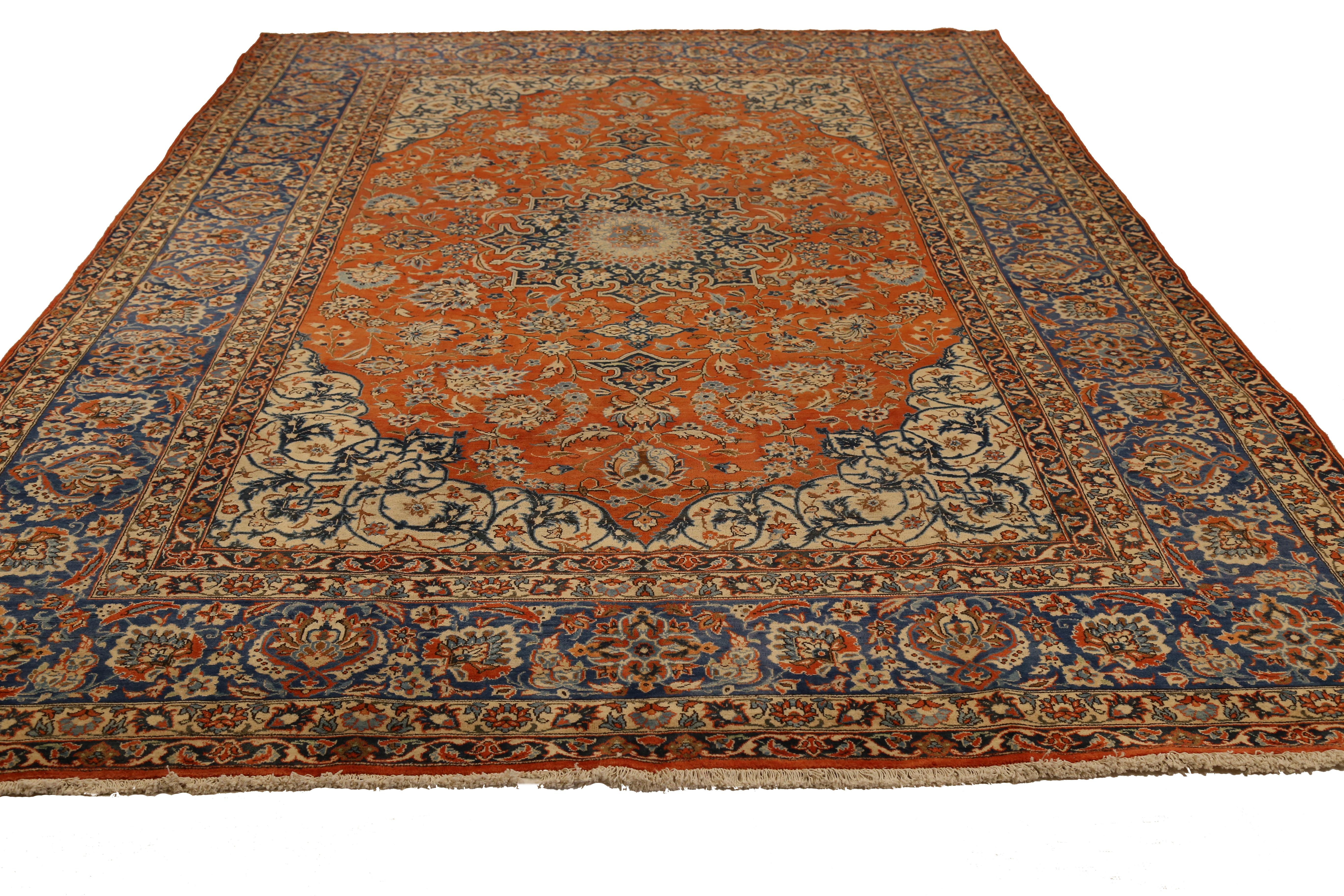 Mid-20th century hand knotted Persian area rug made from fine wool and all-natural vegetable dyes that are safe for people and pets. This beautiful piece features ornate floral patterns in various colors which Isfahan rugs are known for. Persian