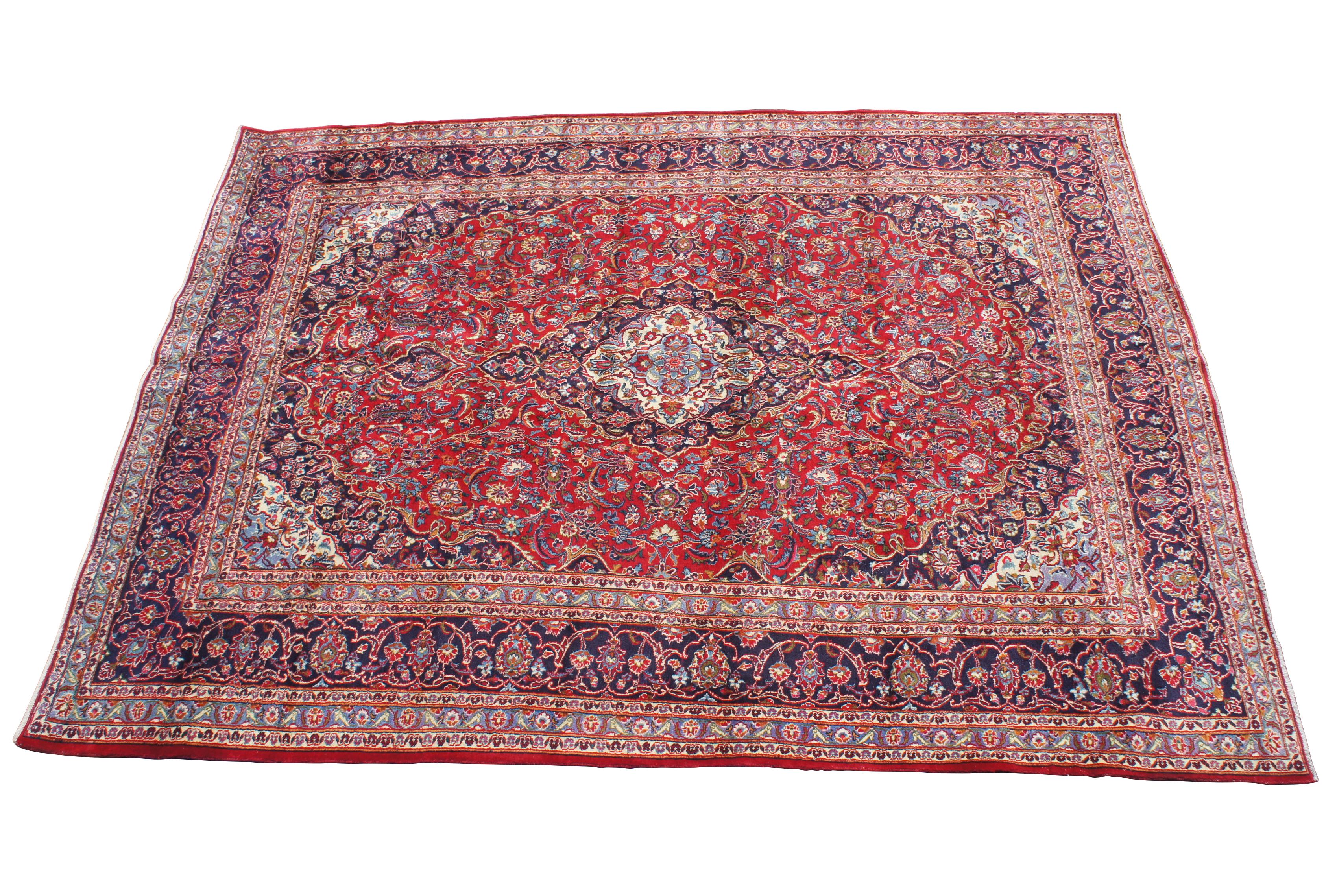 A vibrant mid 20th century Persian Keshan hand knotted wool area rug. Made from 100% wool with a field of red and blue with interlaced floral design. 121-144 knots per square inch 

9' X 12' / 114