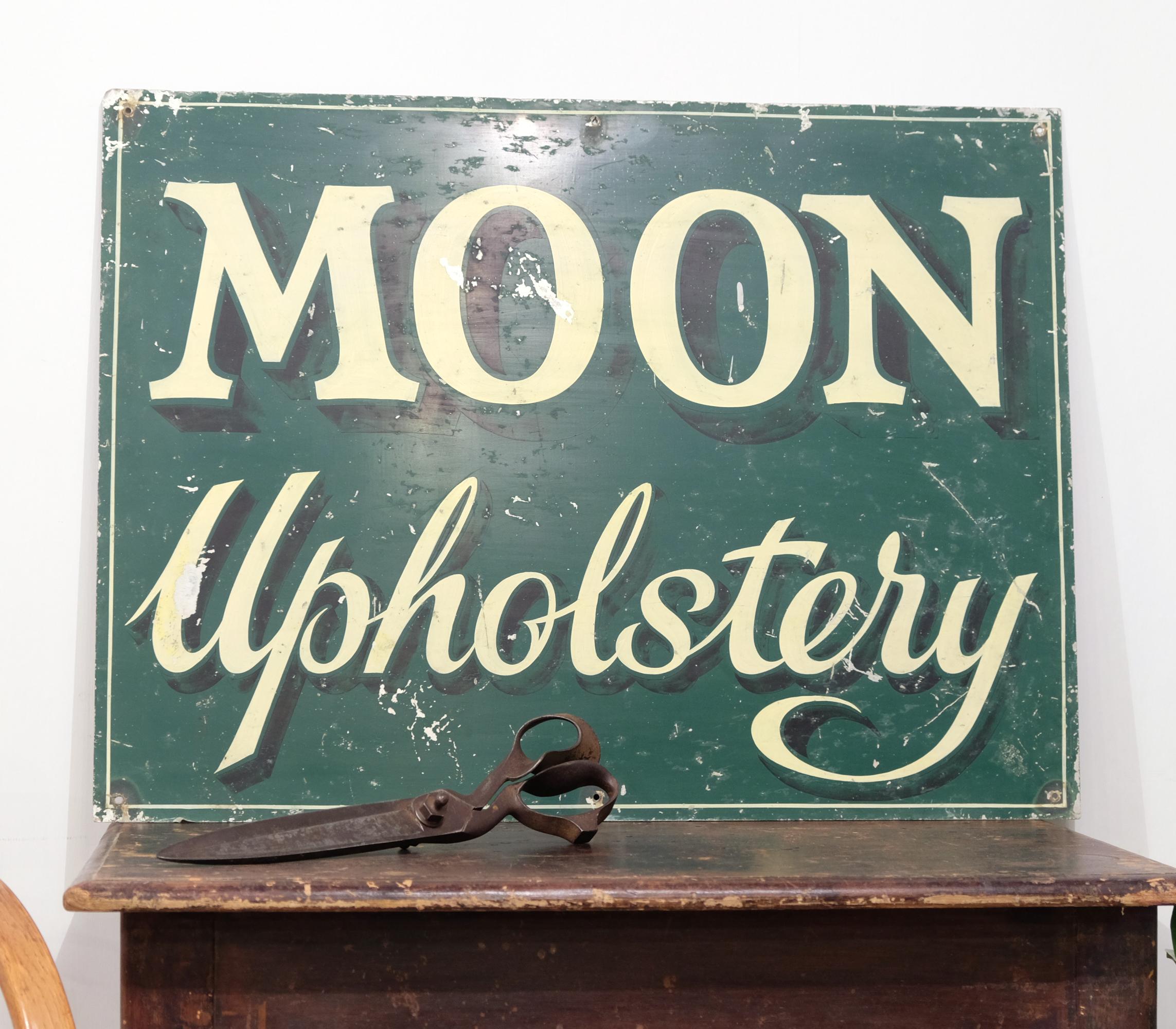Delightful and unique trade sign for a fetchingly named upholsterer's, 'Moon Upholstery'. This trade sign is hand painted on sheet metal and is easily wall mountable with small holes in each corner, circa 1940s.

Free shipping offered to mainland
