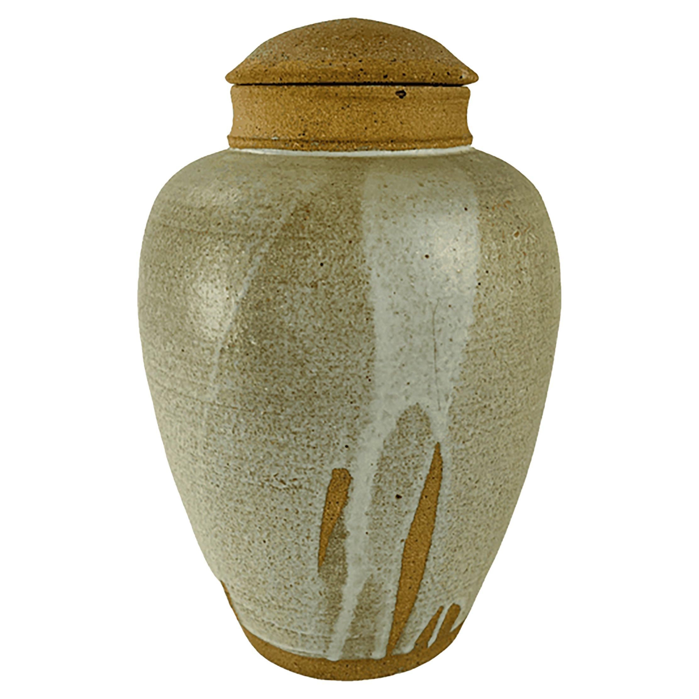 Mid 20th century hand turned clay lidded jar with a lava glazed finish