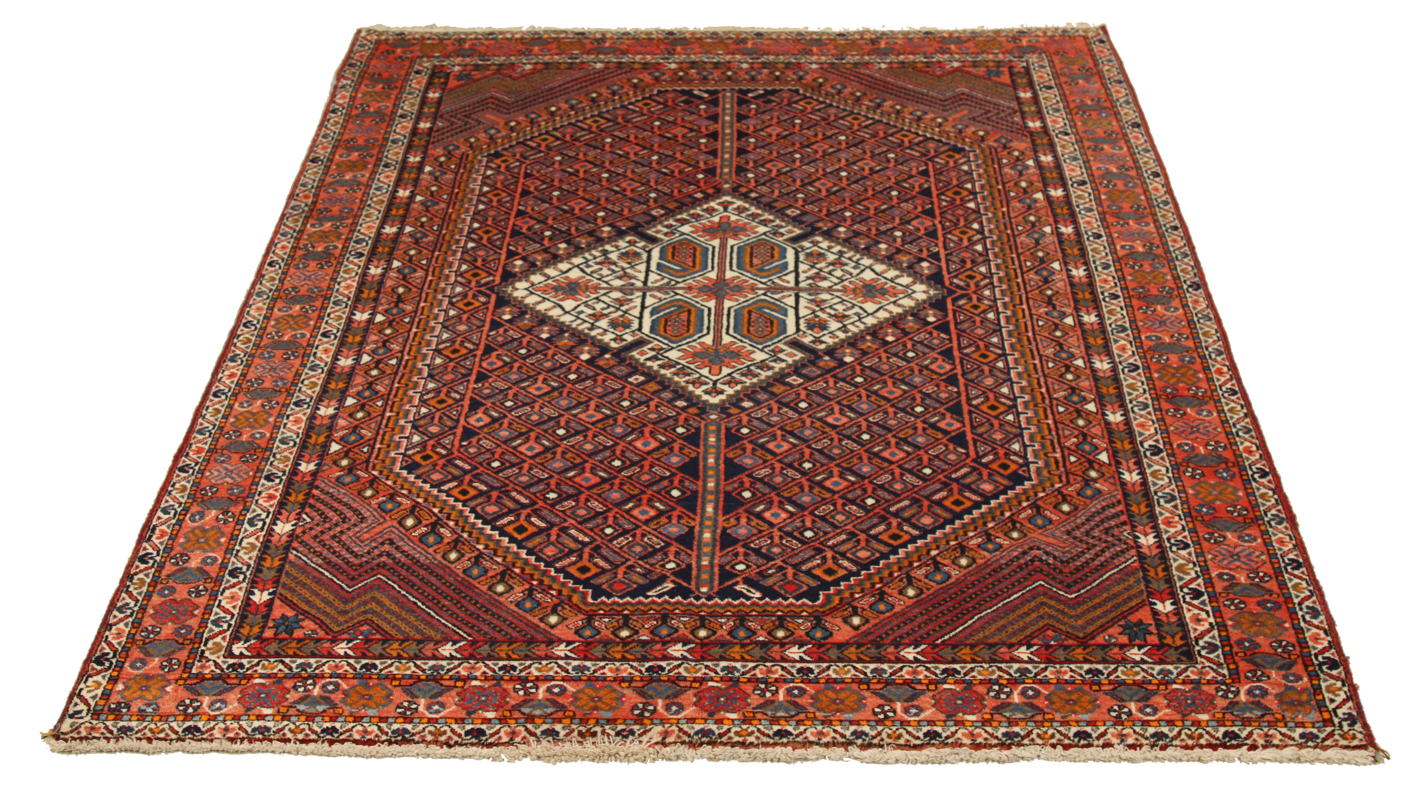 Mid-20th century hand-woven Persian area rug made from fine wool and all-natural vegetable dyes that are safe for people and pets. It features traditional Sirjan weaving depicting intricate geometric patterns mixed with floral elements. It has an