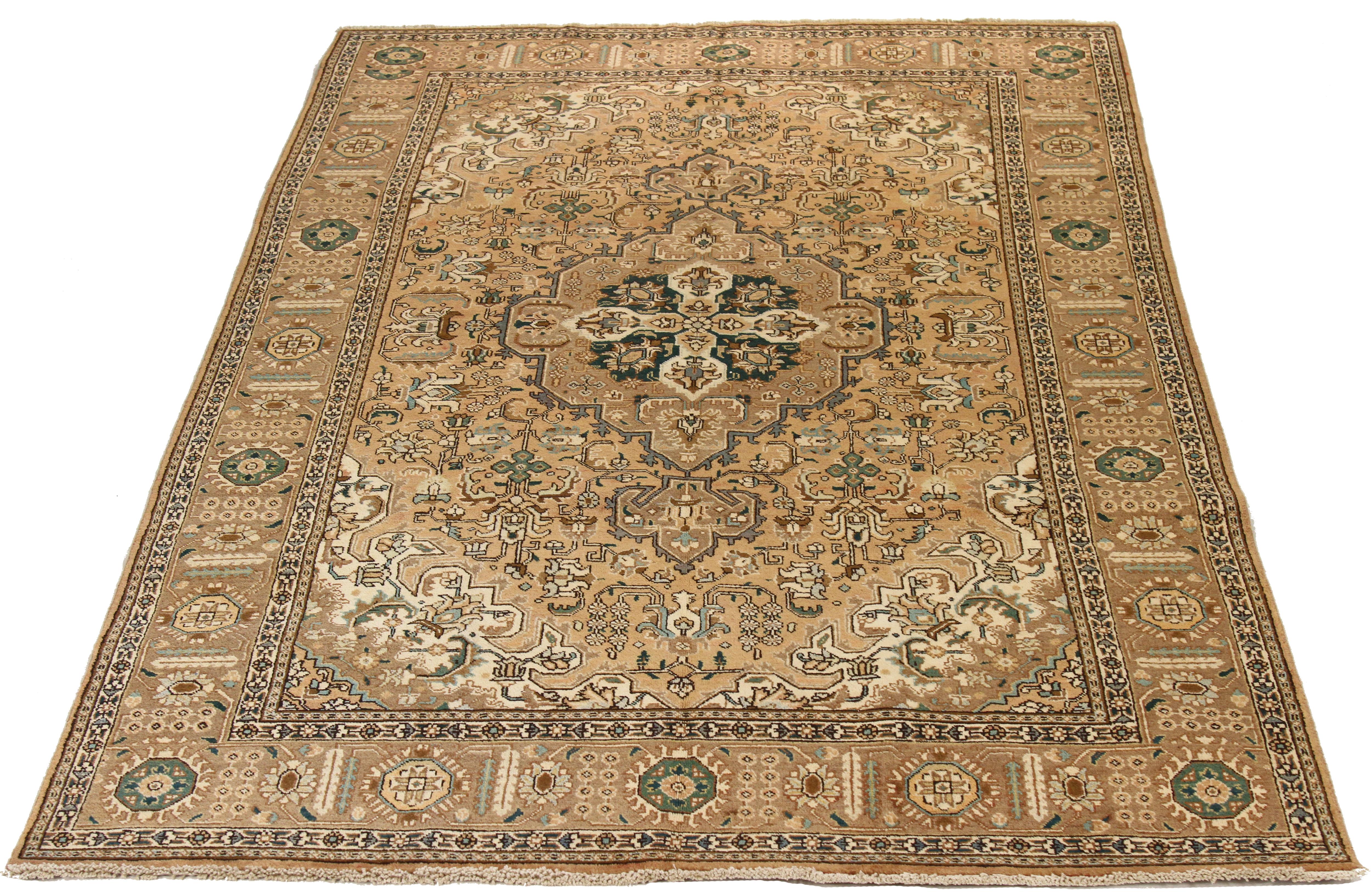Mid-20th century handwoven Persian area rug made from fine wool and all-natural vegetable dyes that are safe for people and pets. This beautiful piece features ornate floral patterns in various colors which Heriz rugs are known for. Persian rugs