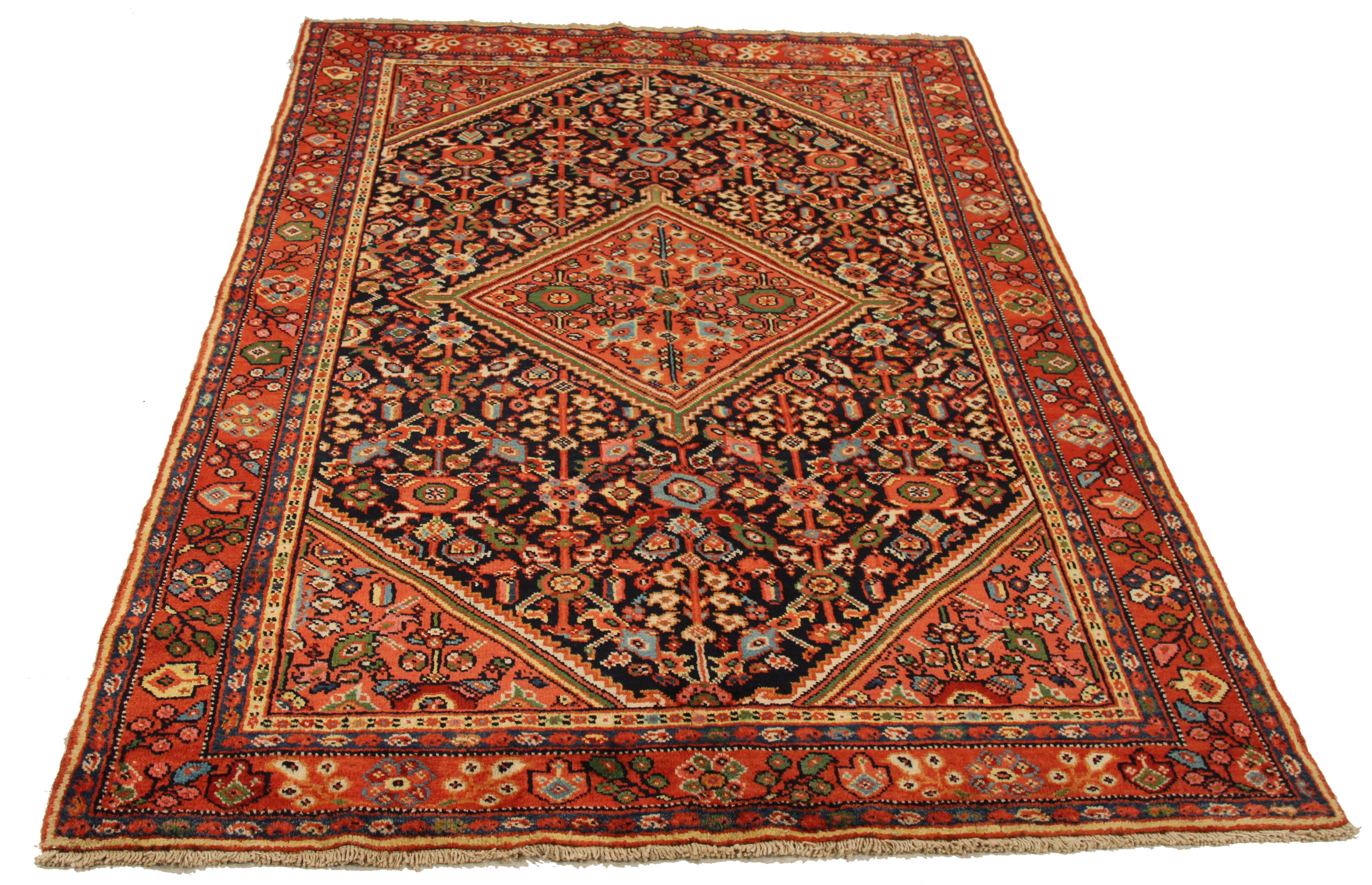 Mid-20th century hand-woven Persian area rug made from fine wool and all-natural vegetable dyes that are safe for people and pets. It features traditional Mahal weaving depicting intricate floral and botanical patterns. 

This area rug has