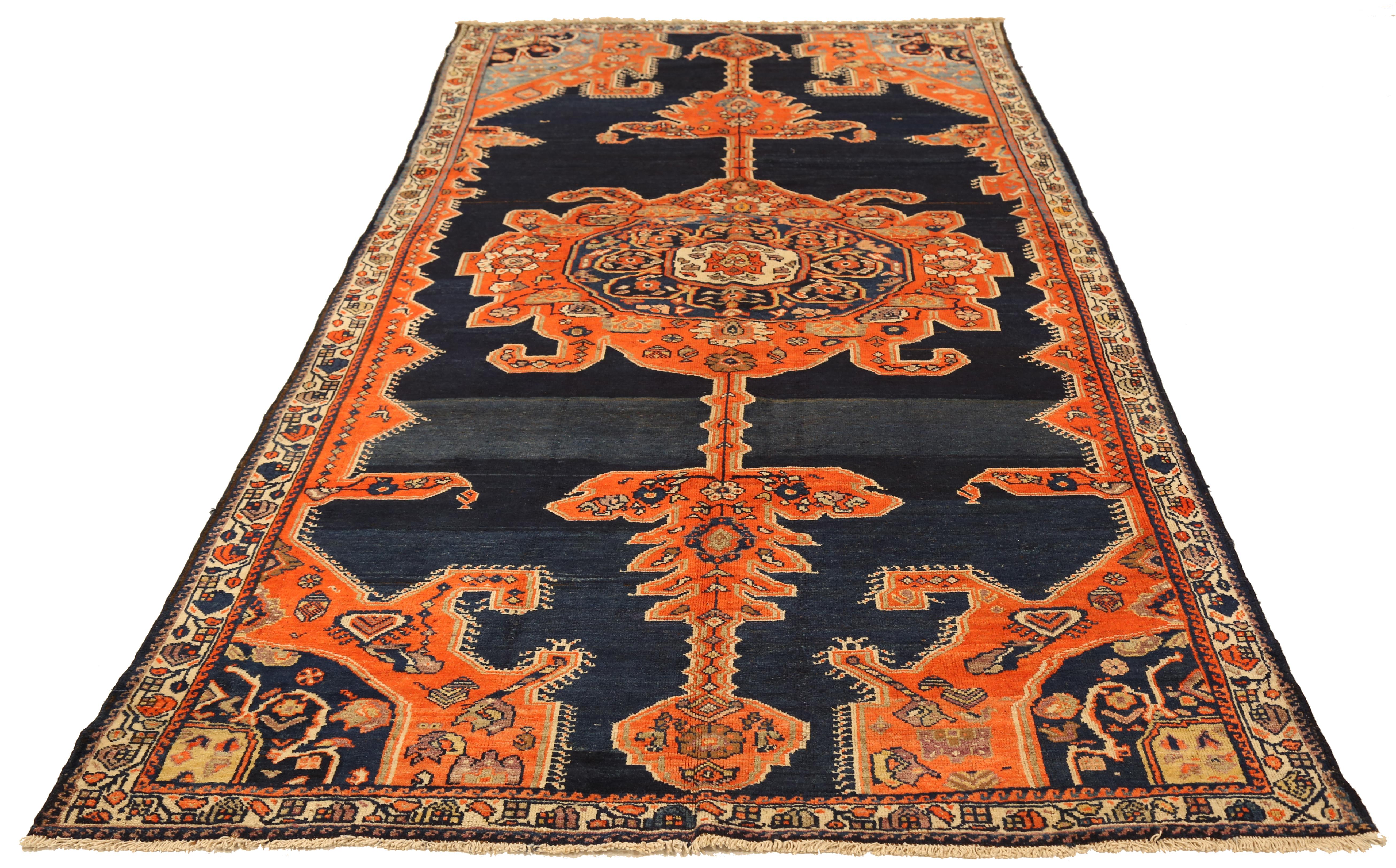 Mid-20th century hand-woven Persian area rug made from fine wool and all-natural vegetable dyes that are safe for people and pets. This piece is a Malayer weaving which is often centered on elaborate 'Boteh' patterns that represents life and