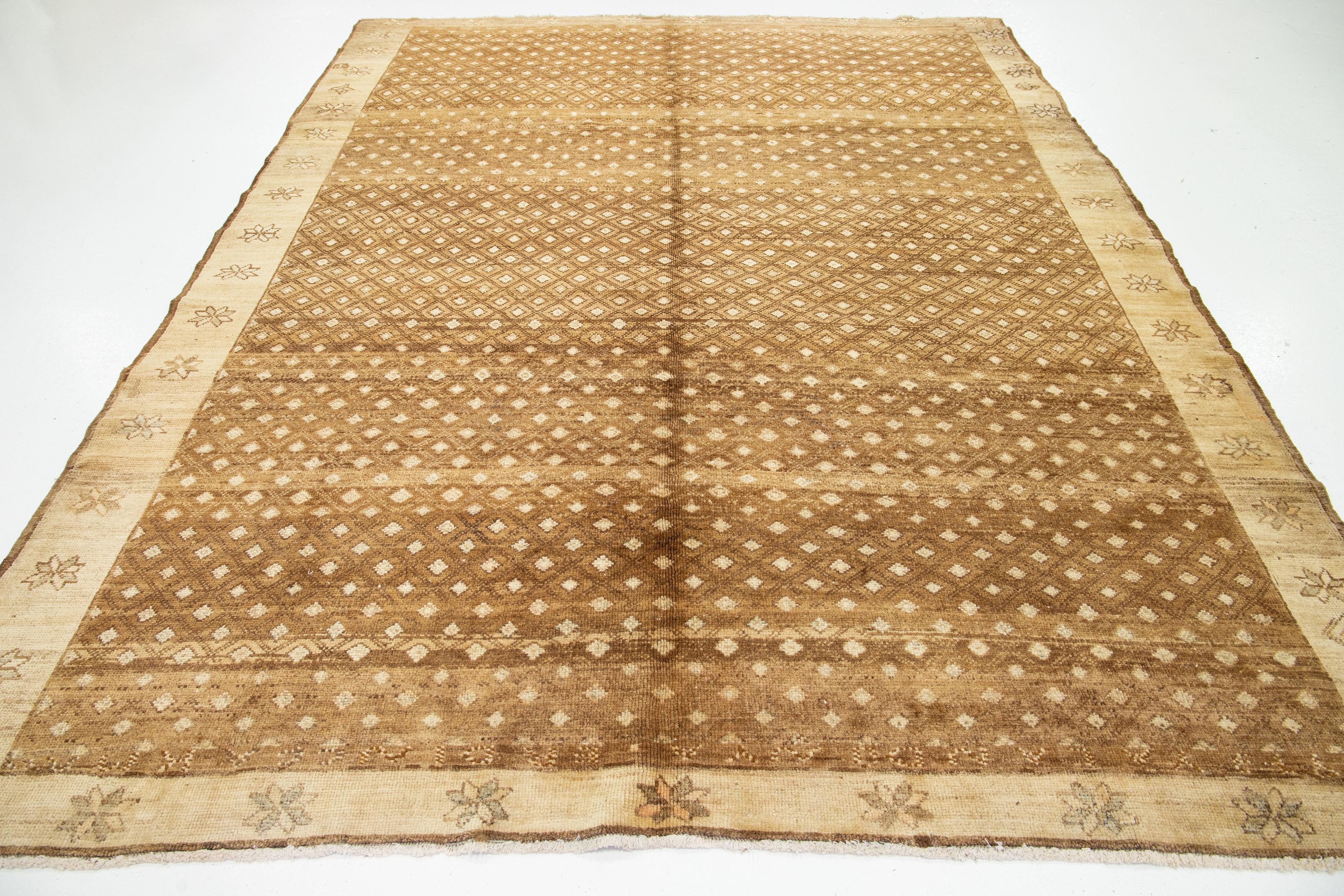 Discover this exquisite vintage Turkish Anatolian Kars rug, meticulously hand-knotted from high-quality wool. The rug features a deep brown field beautifully accented with light brown and tan hues. Its captivating all-over geometric design hails