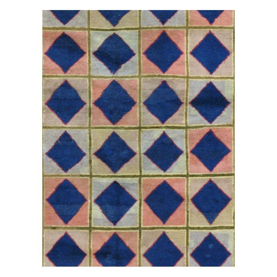 A vintage Indian Art Deco style modernist accent rug handmade during the mid-20th century with a bold design of large scale diamonds within a checkered box pattern and a solid blue border.

Measures: 5' 11