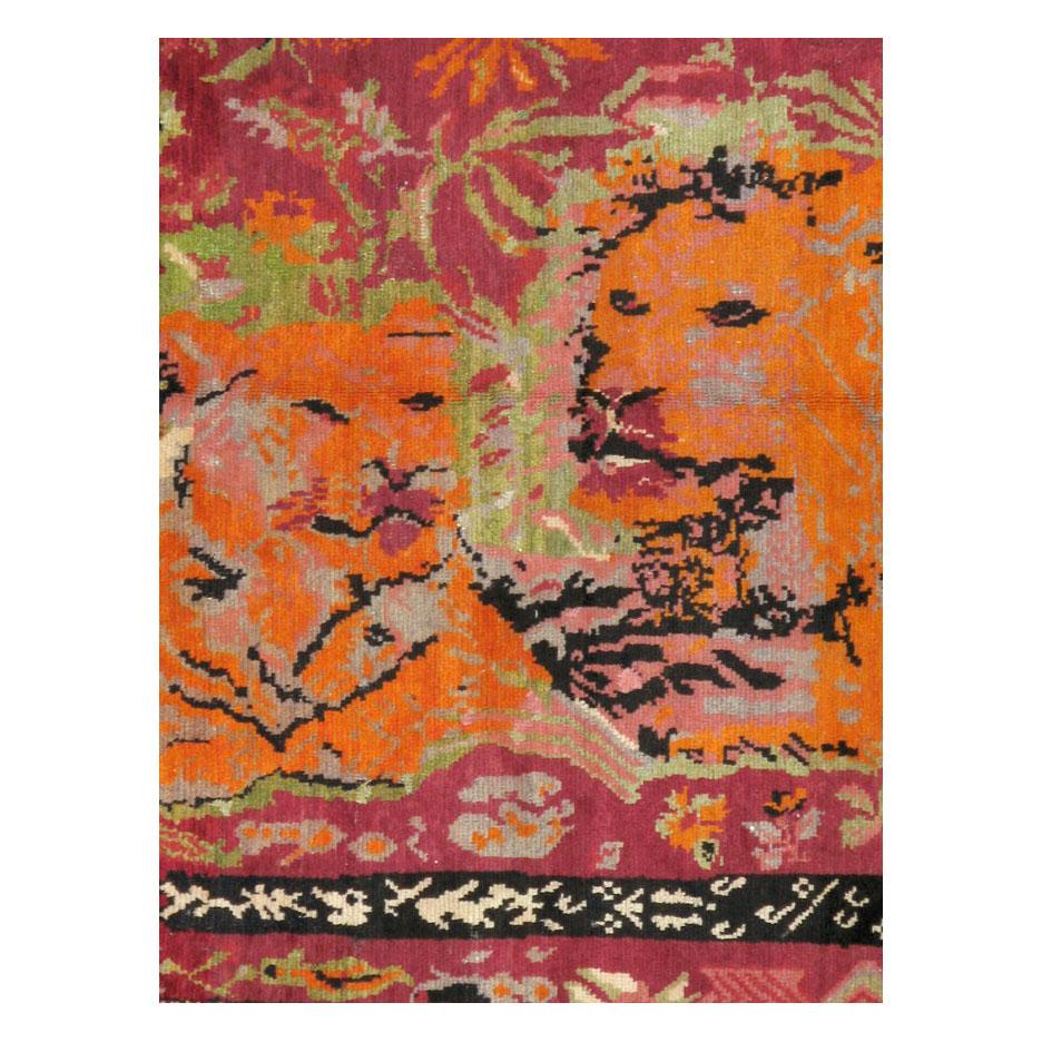 A vintage Caucasian Karabagh accent rug handmade during the mid-20th century with a pictorial design of a lion and lioness.

Measures: 4' 4