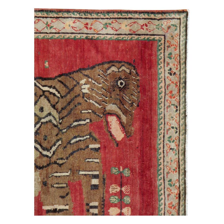 A vintage Caucasian Karabagh accent rug handmade during the mid-20th century with an informally rendered pictorial depiction of a tiger.

Measures: 4' 4