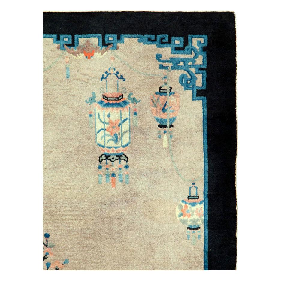 A vintage Chinese Peking scatter rug handmade during the mid-20th century with a beige field, black border, and an intricate guard border with hints of blue and blue-green.

Measures: 3' 8