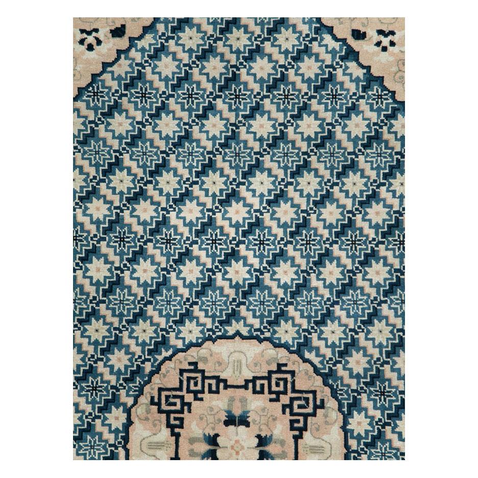 A vintage Chinese Peking accent rug handmade during the mid-20th century with a cerulean blue field, cream medallion, border, and corner spandrels, and dark blue guard borders.

Measures: 6' 2