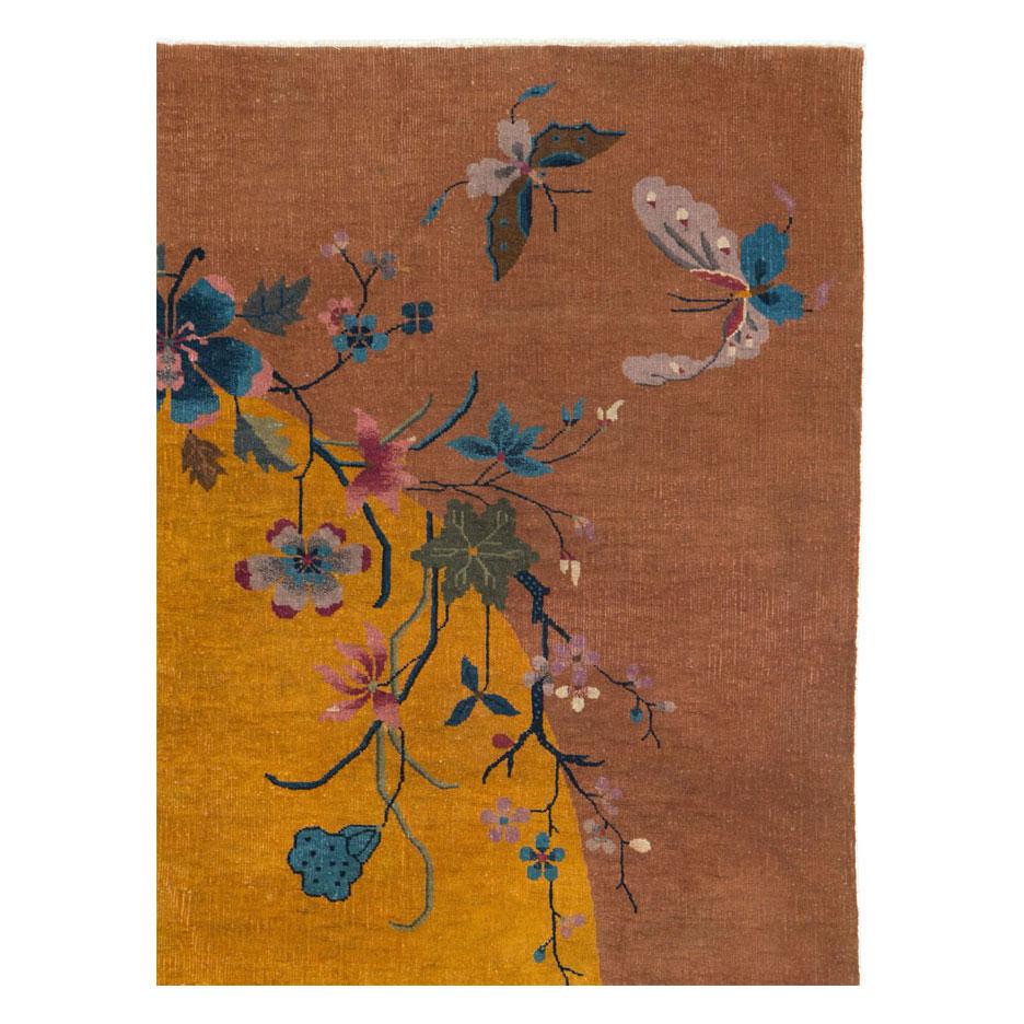 A vintage Chinese Art Deco accent rug handmade during the mid-20th century with a circular mustard yellow field and large terracotta border. 2 Chinese lanterns hand from the branches as butterflies float about.

Measures: 6' 0