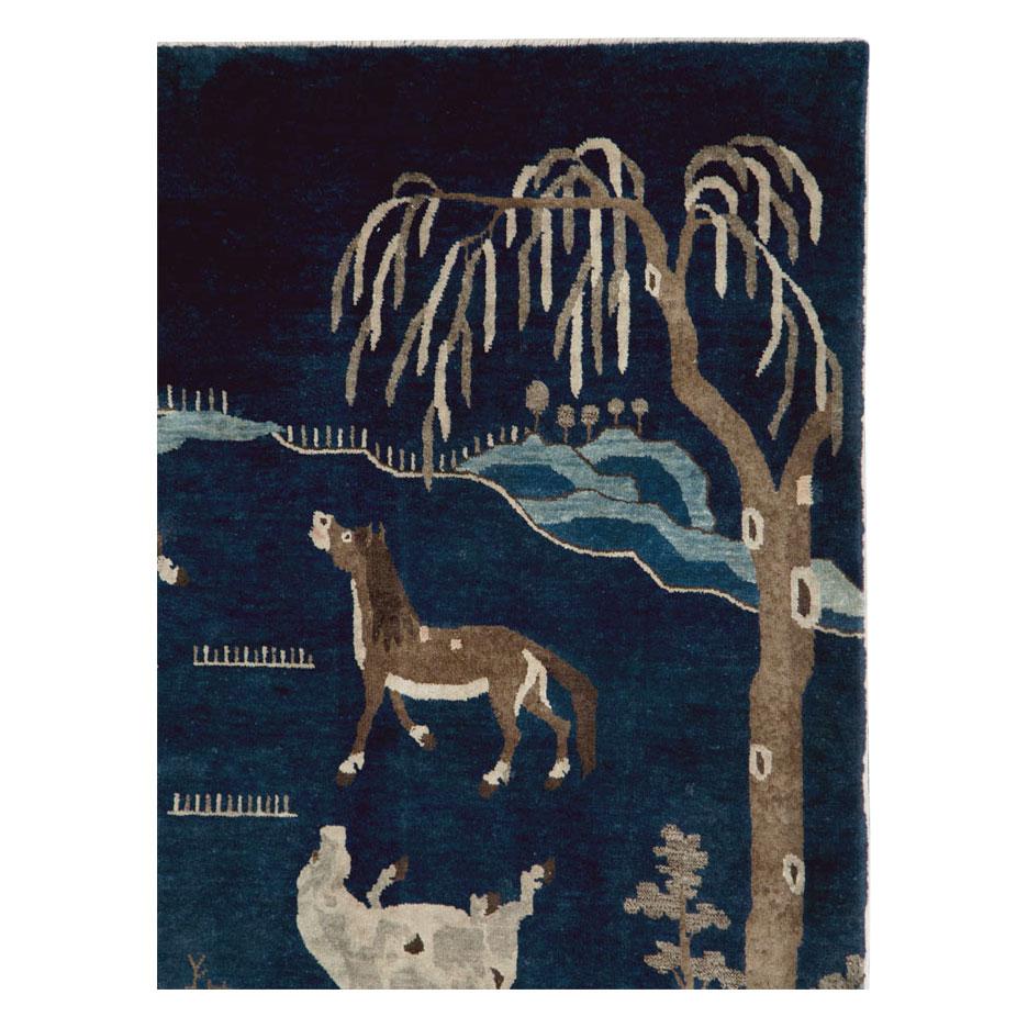 A vintage Chinese pictorial accent rug handmade during the mid-20th century of horses prancing in a field over a dark midnight blue background.

Measures: 4' 0