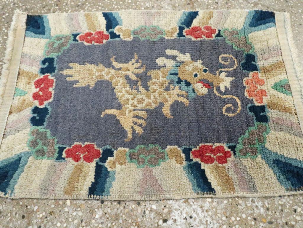 A vintage Chinese Peking throw rug handmade during the mid-20th century with a pictorial design of a dragon.

Measures: 1' 3