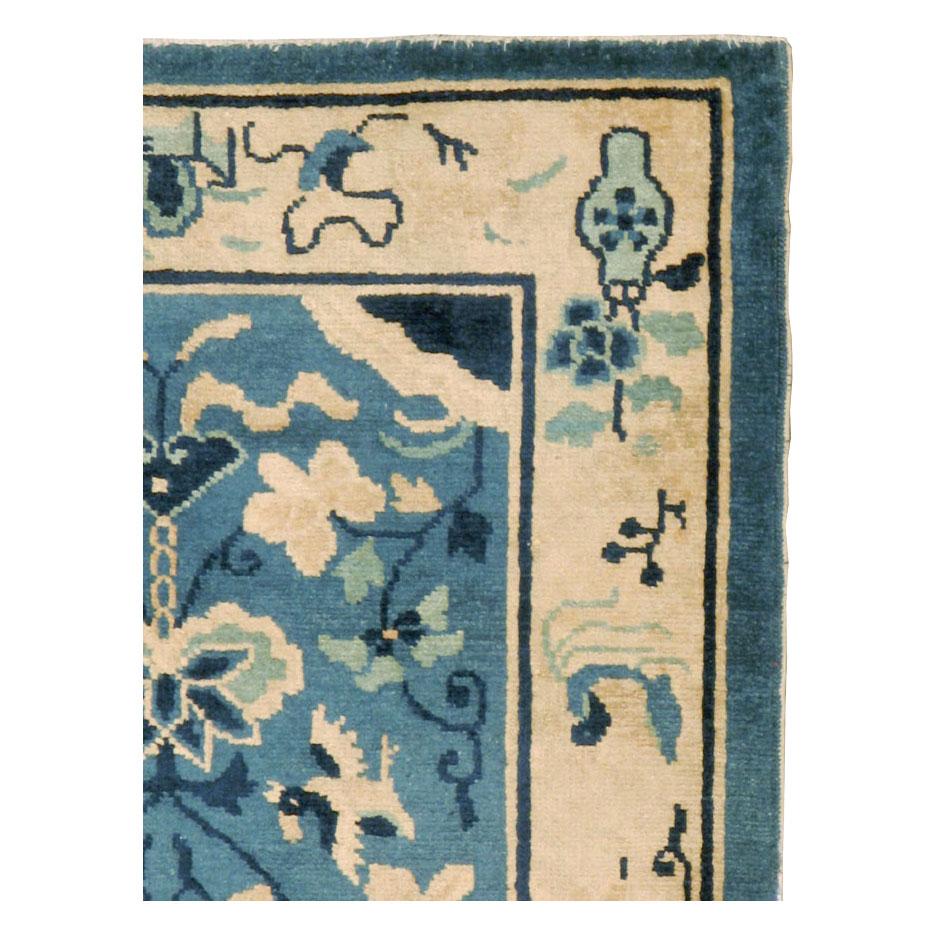 A vintage Chinese Peking throw rug handmade during the mid-20th century with a cream border and light blue field.

Measures: 2' 6