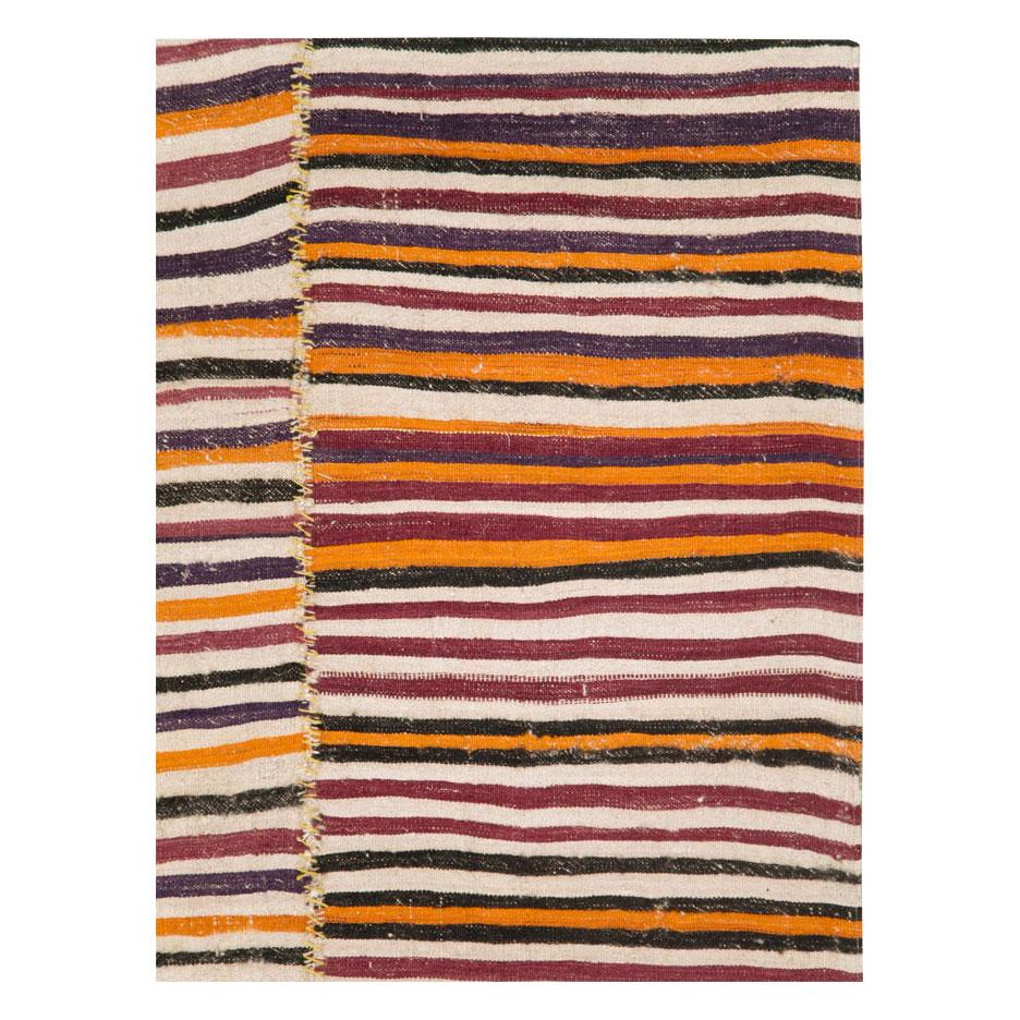 A vintage Persian tribal flat-weave Kilim accent rug handmade during the mid-20th century with 3 striped colorful columns incorporating cream, aubergine, and maroon, charcoal brown, and orange.

Measures: 6' 2