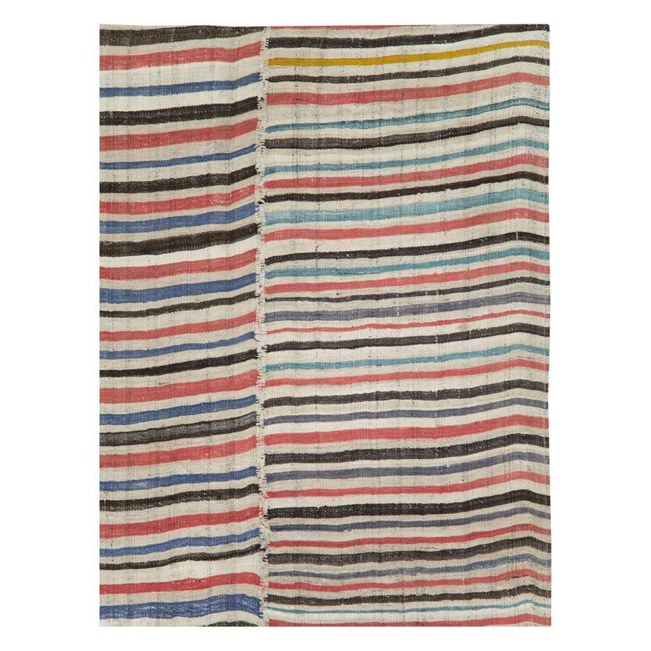 A vintage Persian tribal flat-weave Kilim accent rug handmade during the mid-20th century with 4 striped colorful columns with white bindings.

Measures: 6'7